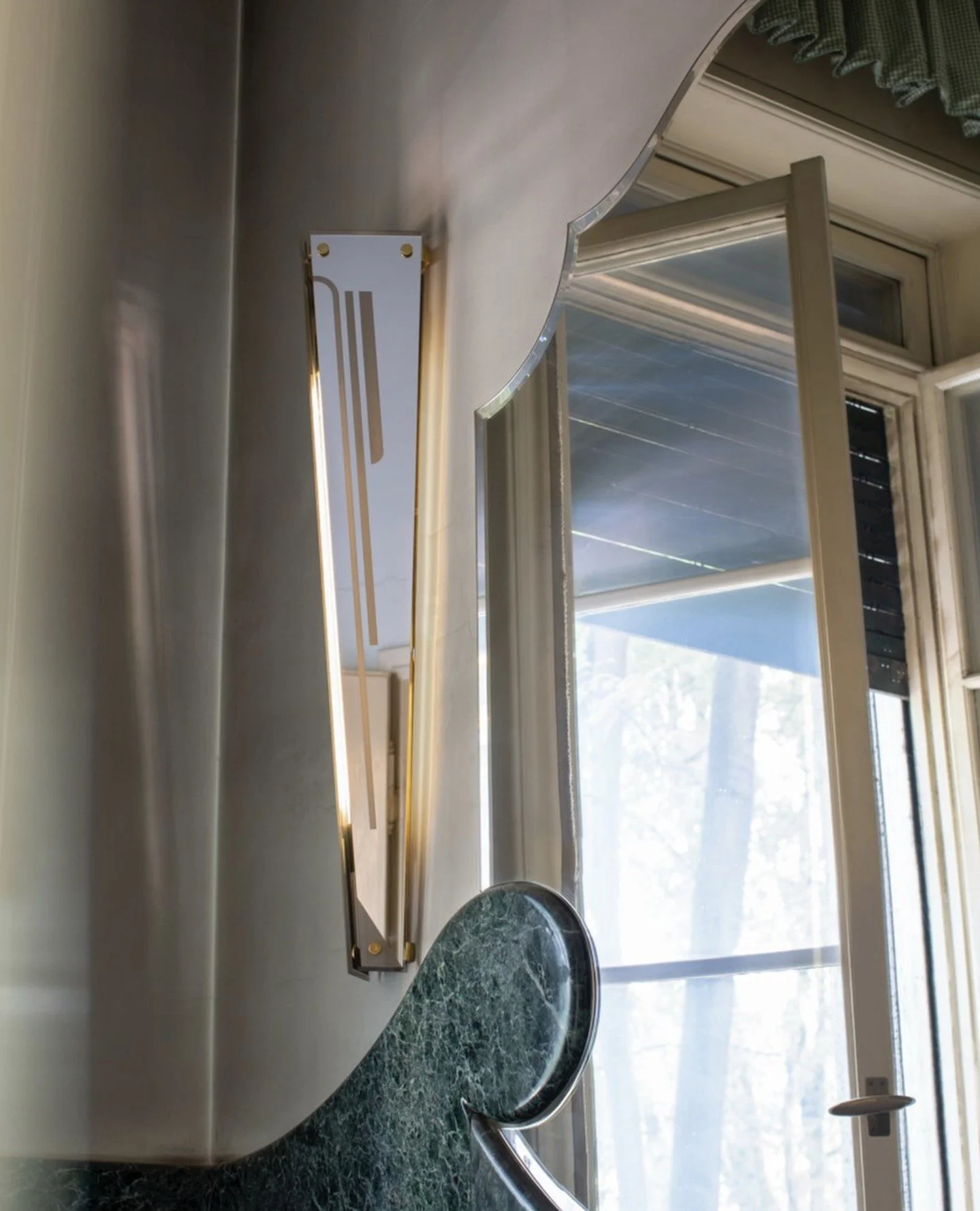 The Pietro Applique, designed by Dimorestudio for Dimoremilano⁠, is a wall light with a decorated mirror shade and brass details.⁠
⁠
@dimoremilano⁠ Photographed by @silviarivoltella