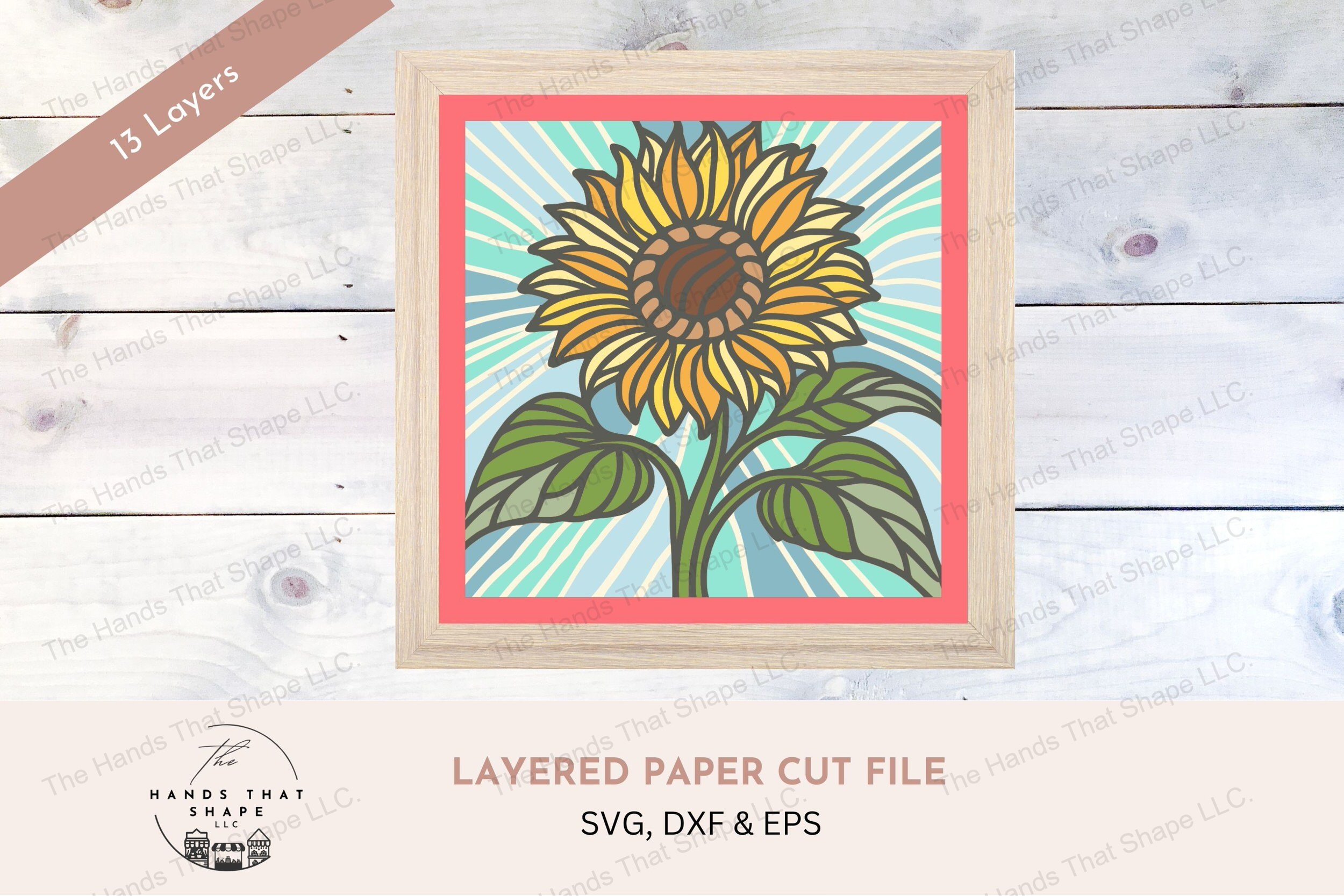 This layered cardstock art piece beautifully captures a vibrant sunflower, set against a striking blue background that radiates outward.