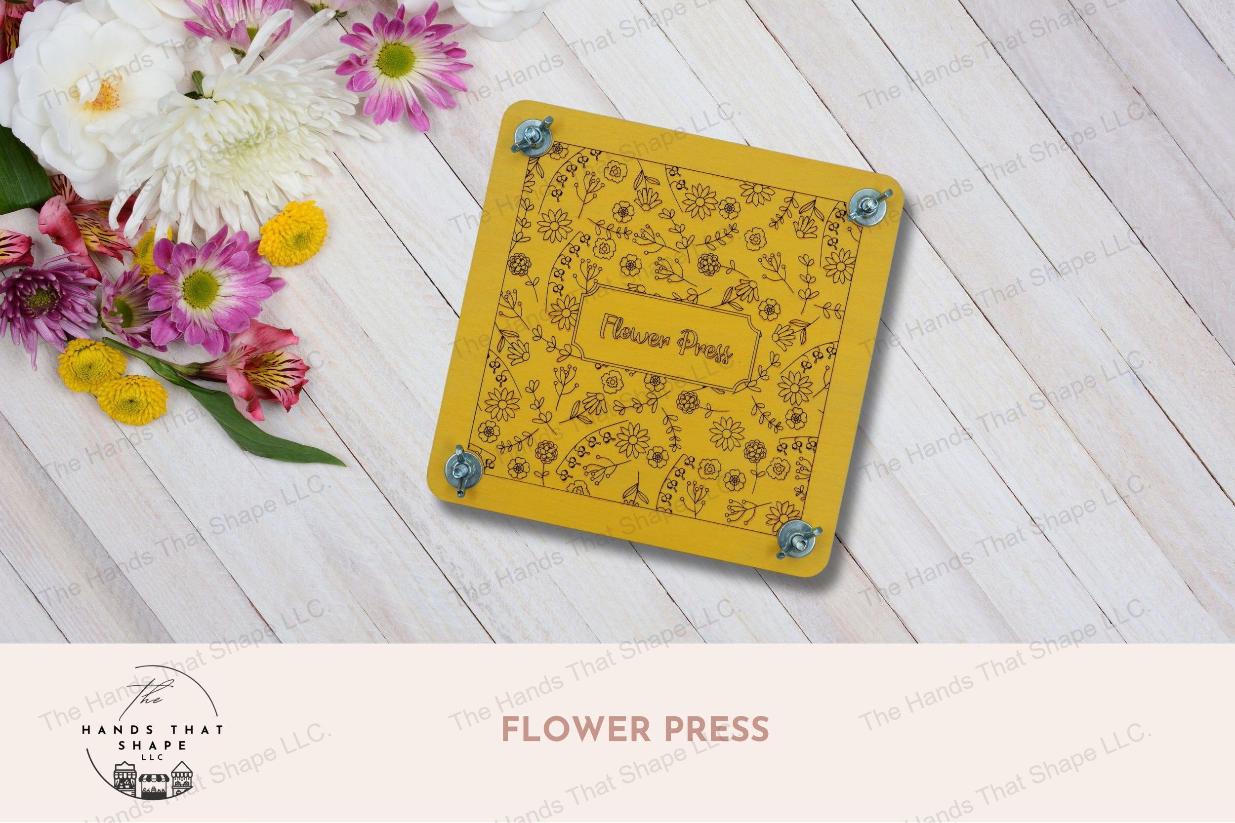 A decorative wooden flower press with laser-marked floral design, complete with cardboard and parchment layers for preserving blooms, yellow version.