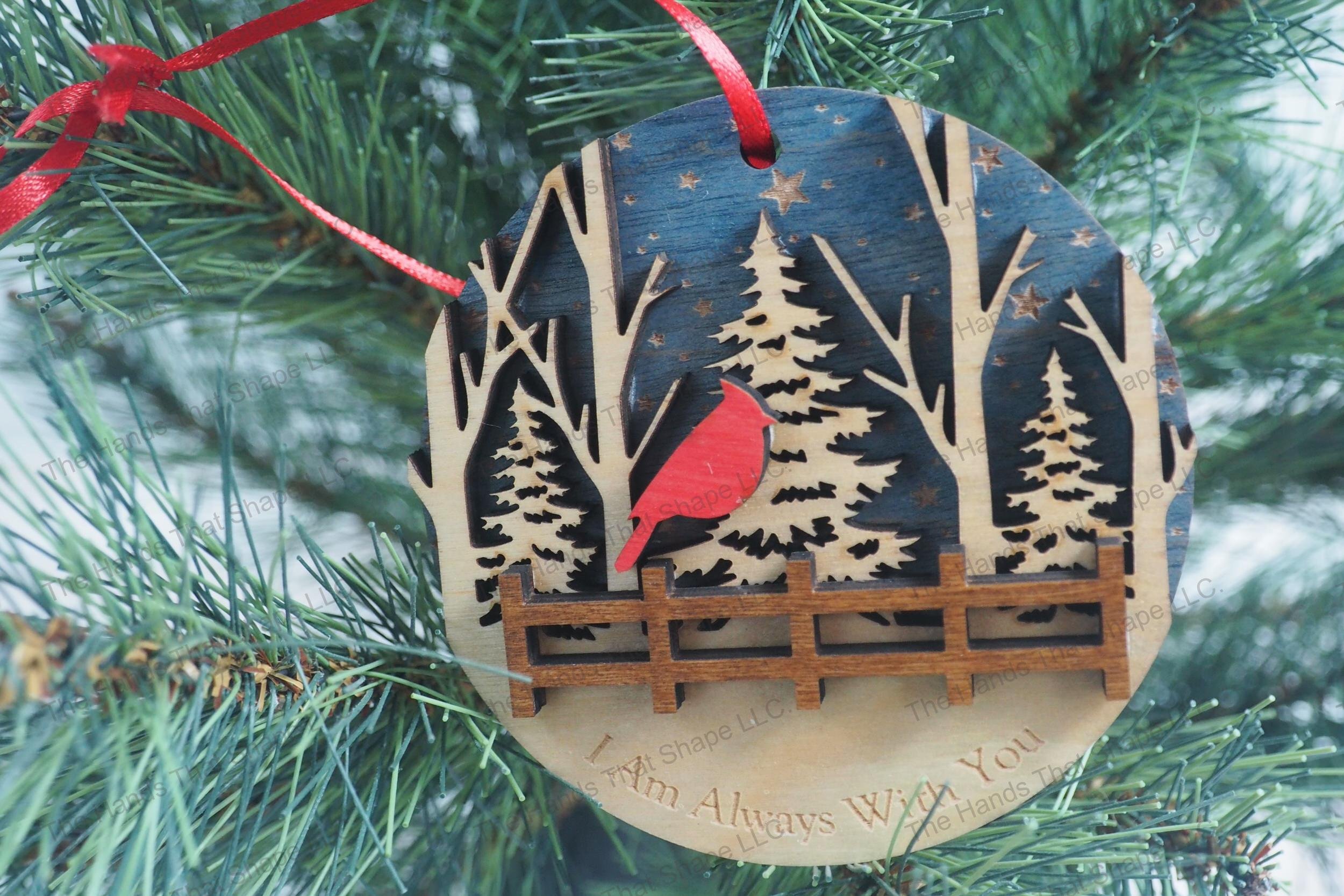 A Christmas tree adorned with our beautifully crafted wooden ornament, featuring one cardinal in a multi-layered design and a heartfelt engraving.