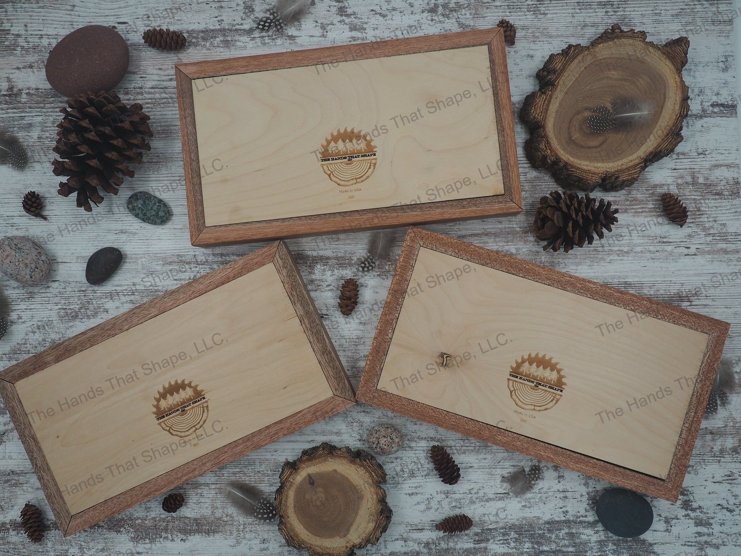 Examples of the back side of the small nature scene showing The Hands That Shape, LLC logo