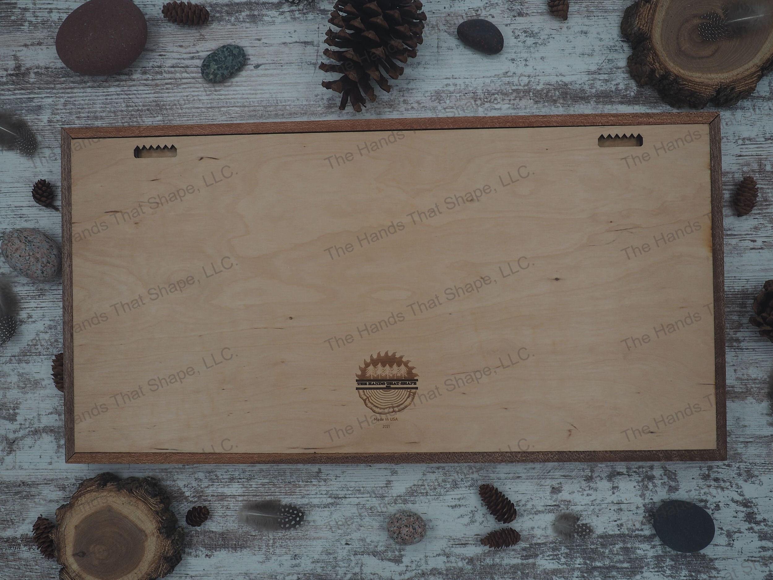 Example of the back side of a large nature scene showing The Hands That Shape, LLC logo and built in hangers