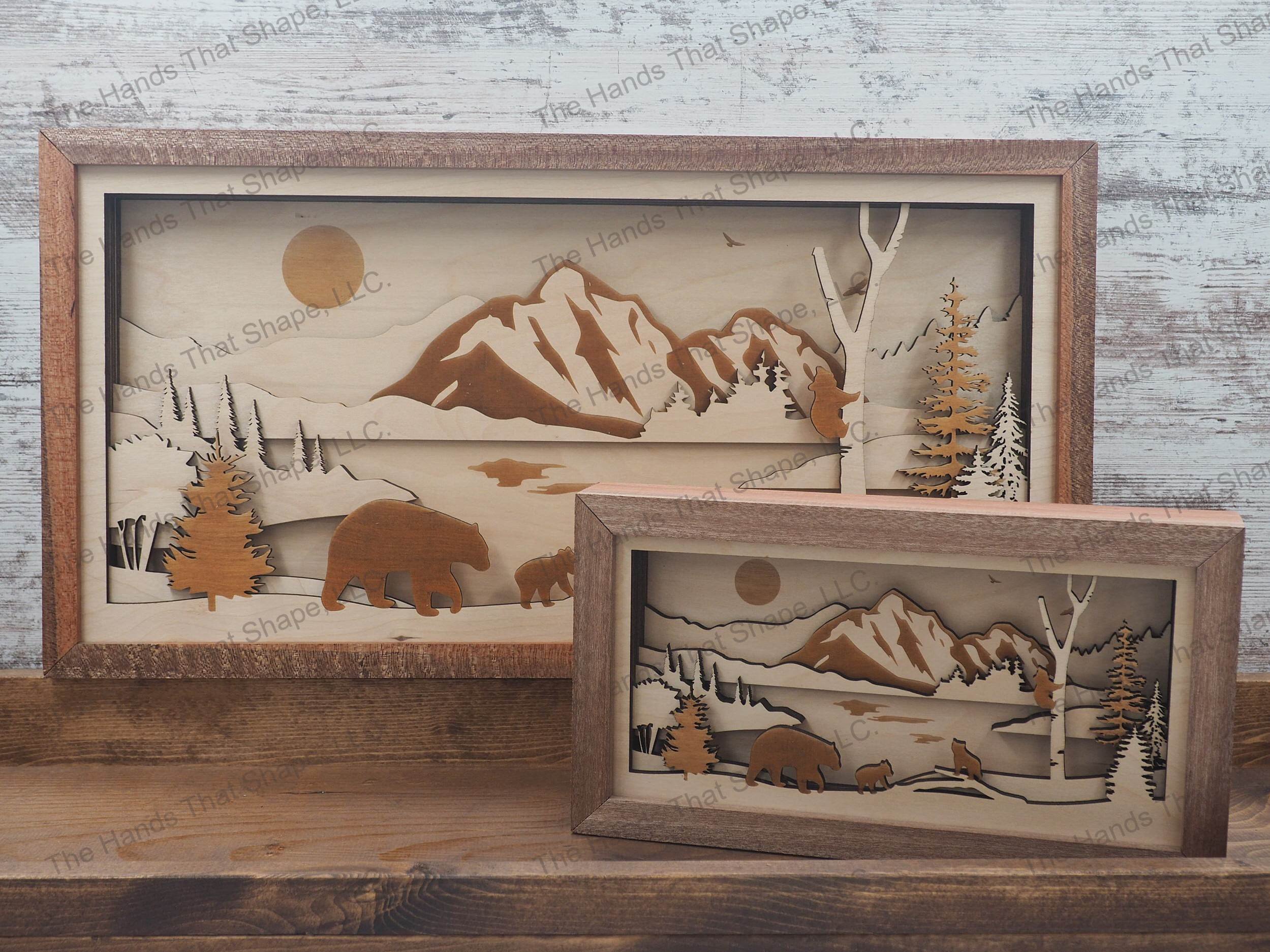 mama bear and cubs playing around a river with a majestic mountain range and eagle towering above