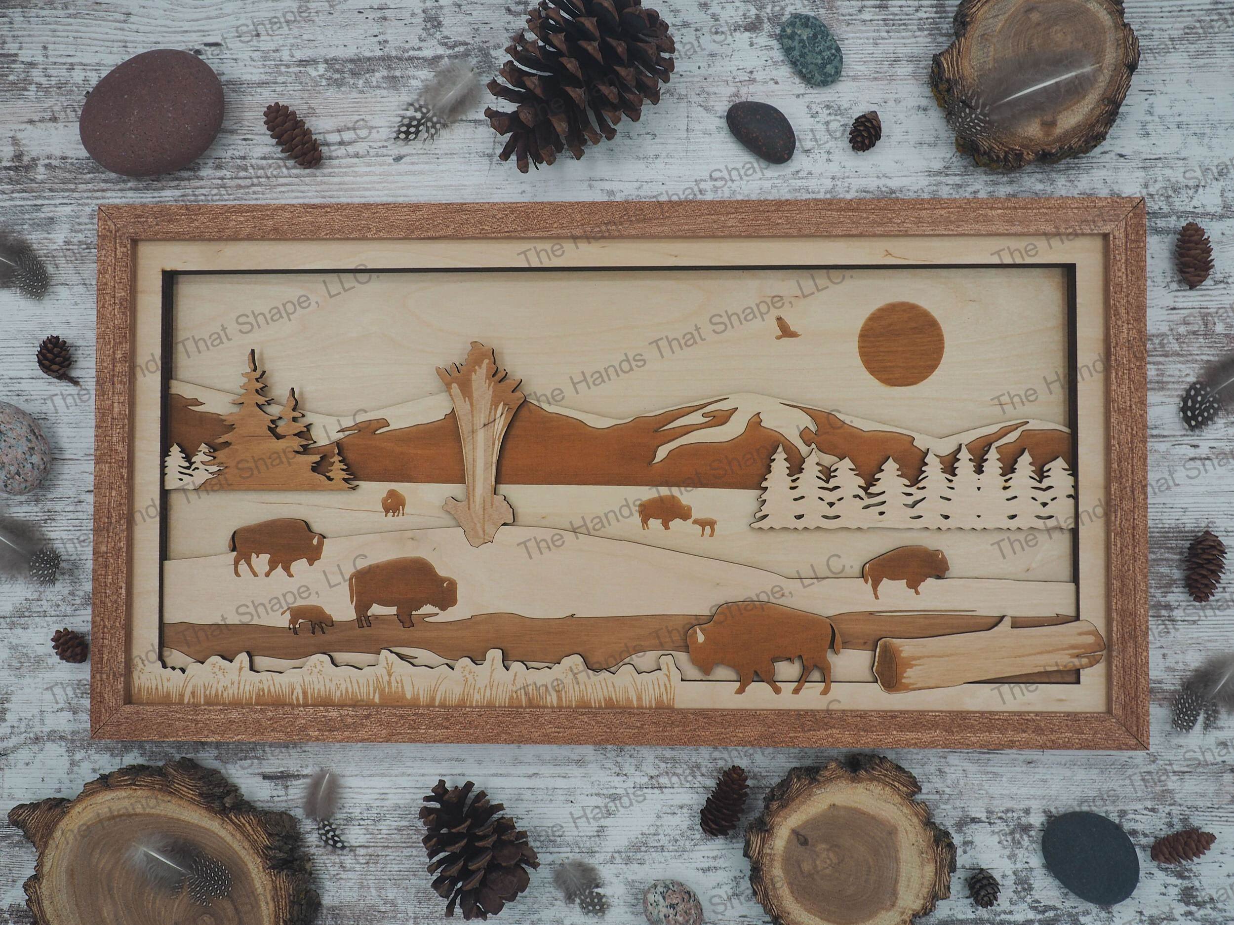A herd of bison grazing around an active geyser with a majestic mountain range towering in the background.