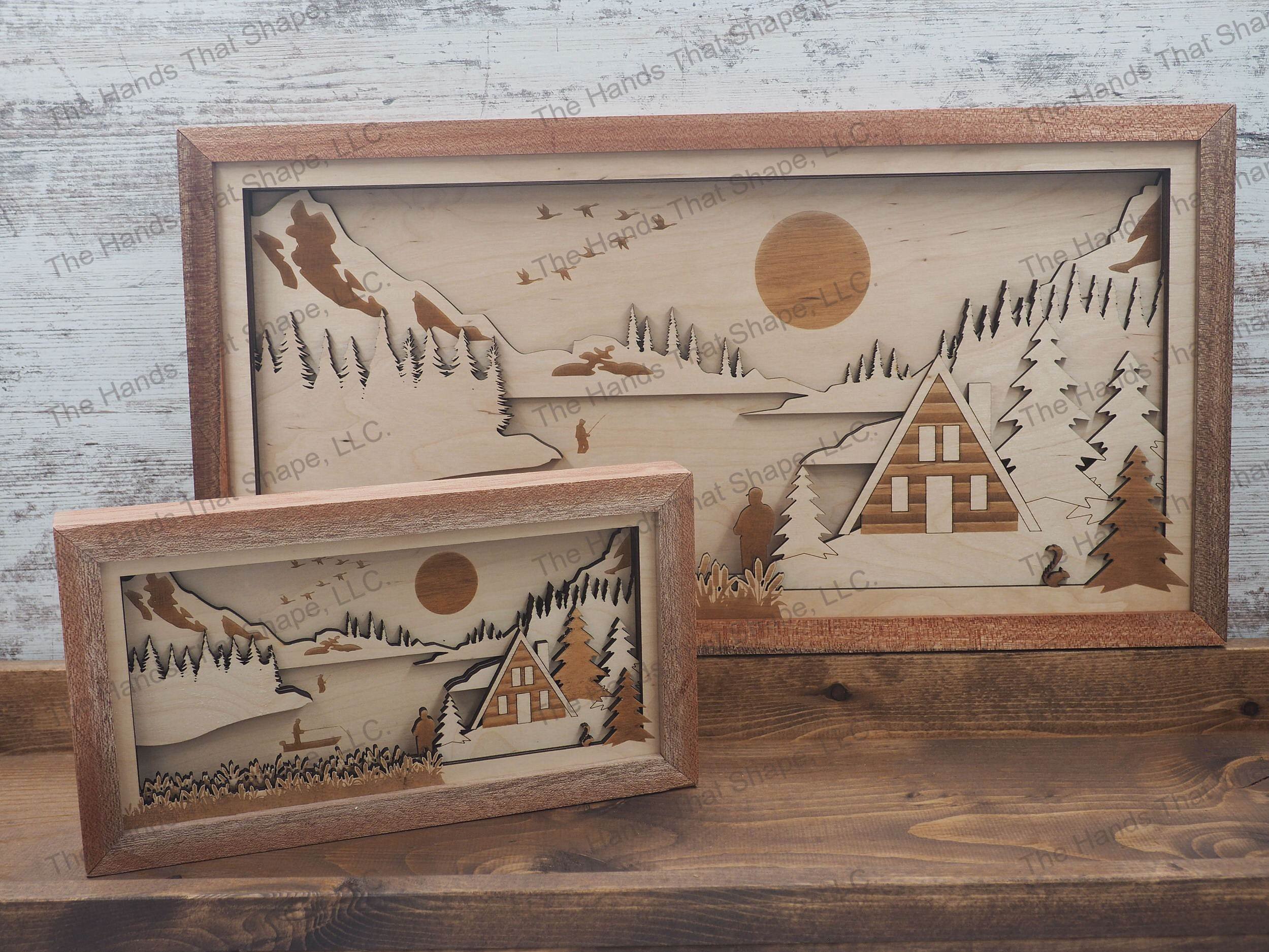 3D shadowbox with a lake front cabin, fishing from shore and boat, pine forest and a majestic mountain range.