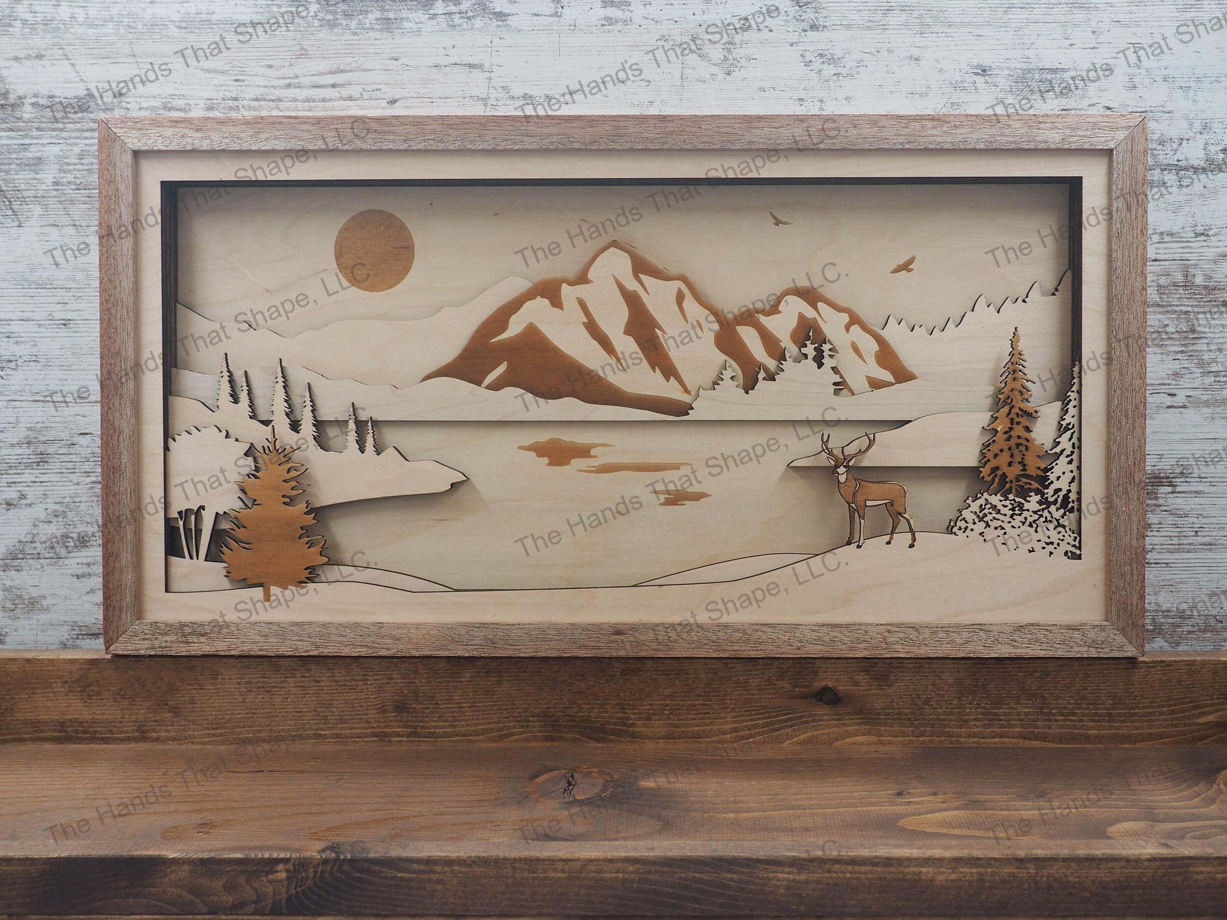 A Mighty Buck overlooking a tranquil river with a majestic mountain range and eagle towering above.