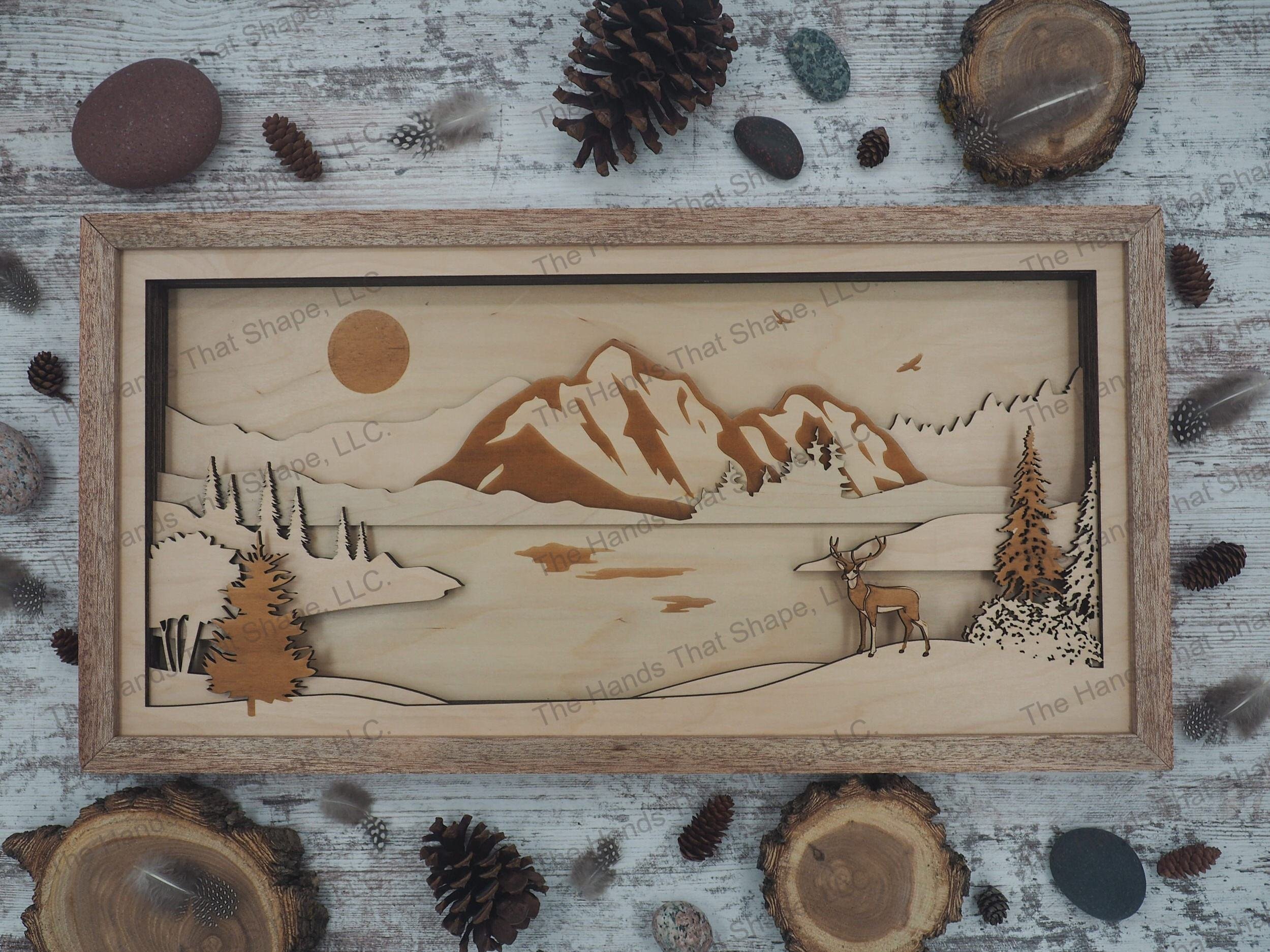 A Mighty Buck overlooking a tranquil river with a majestic mountain range and eagle towering above.
