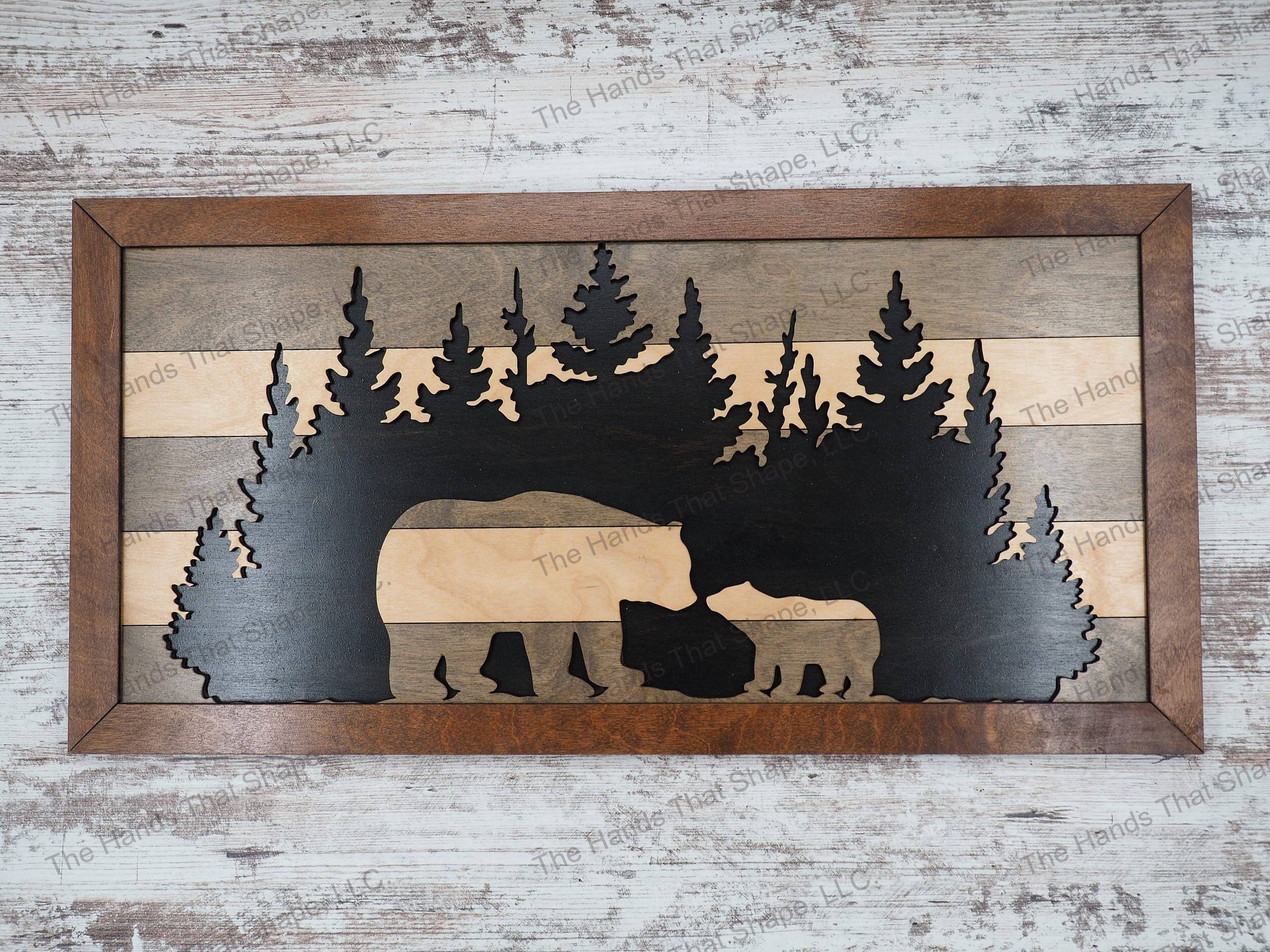 The wall art features a gray striped mama bear and cub design set against a forest cutout and black background.