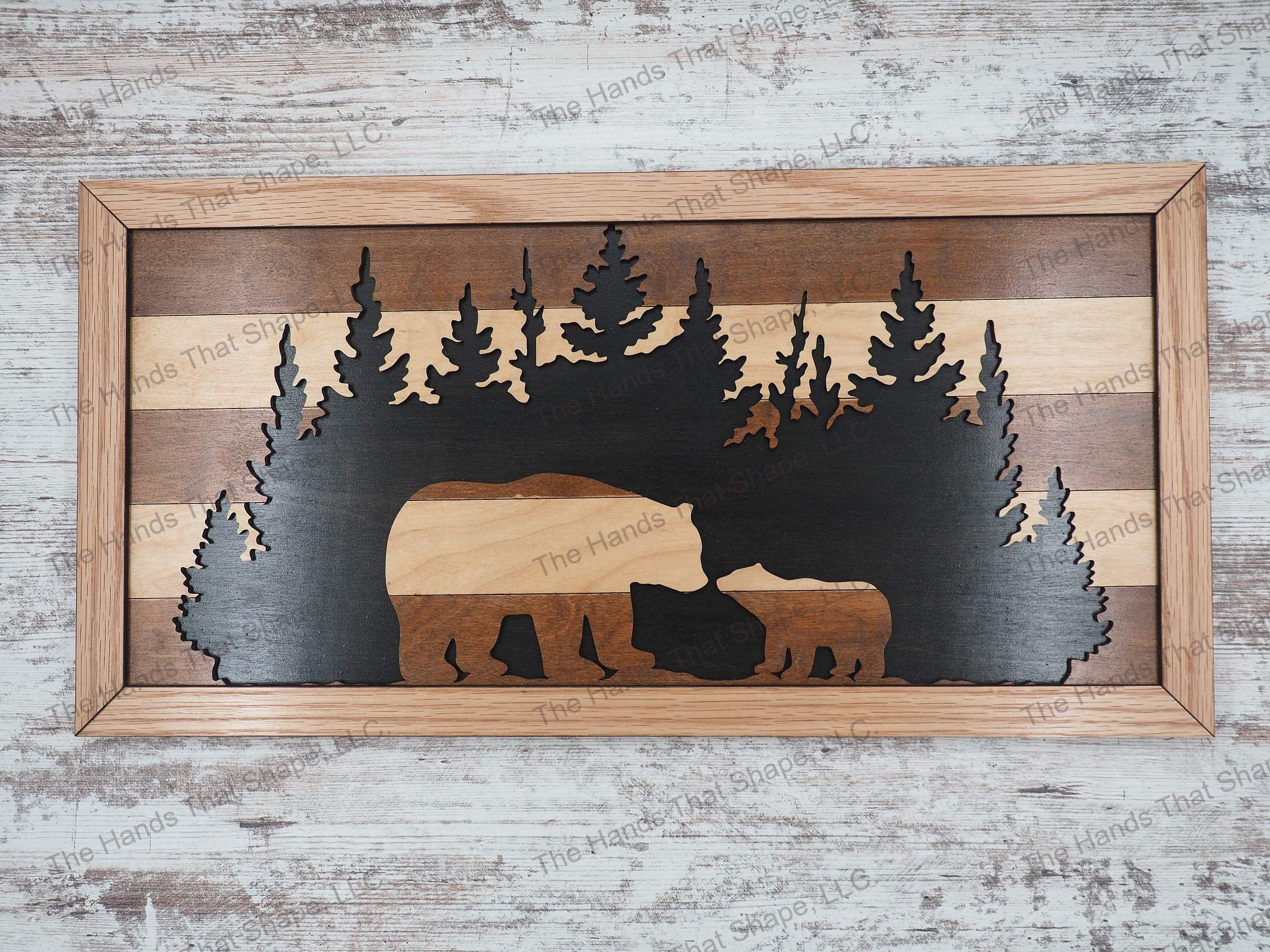The wall art features a brown striped mama bear and cub design set against a forest cutout and black background.