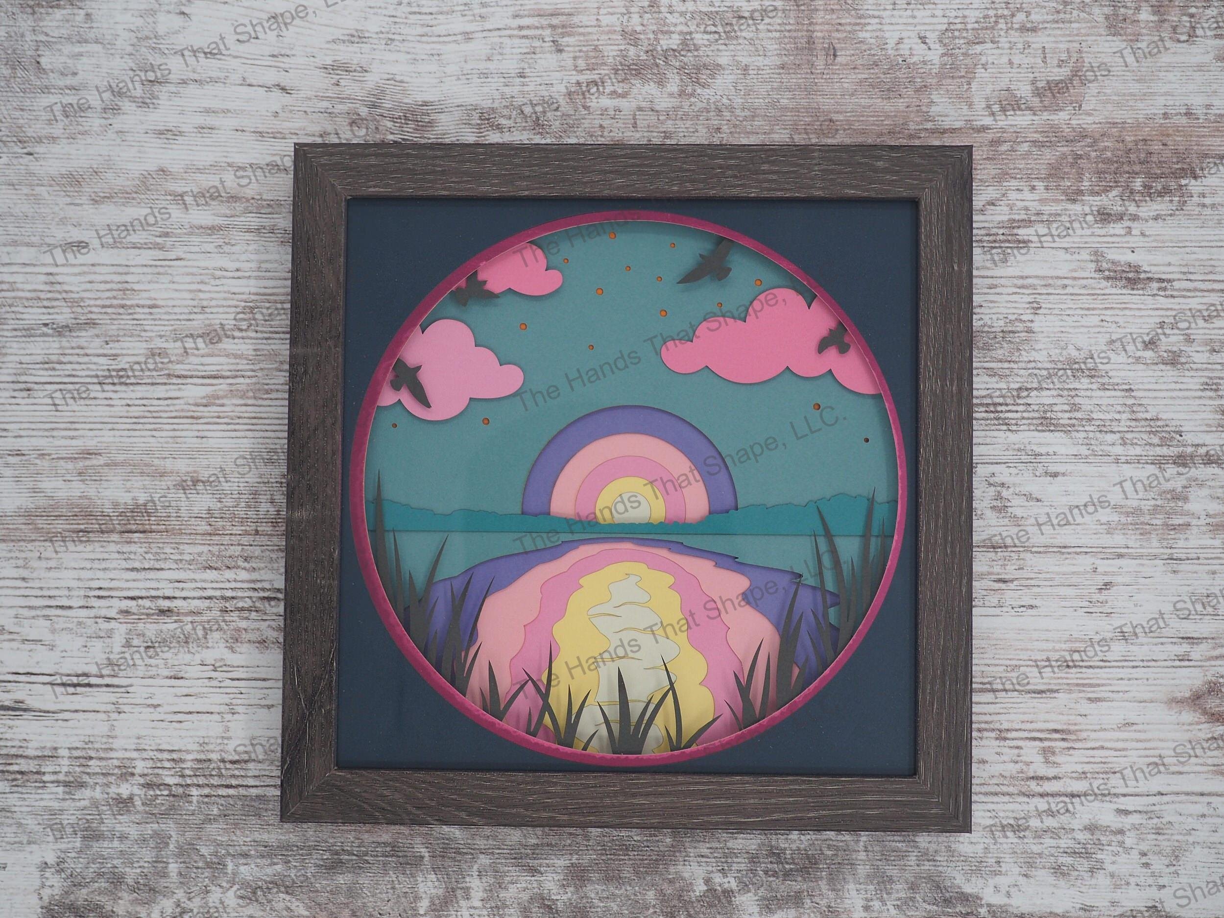 The shadow box features the setting sun about to pass over the horizon creating such a majesty of colors dancing over the water and clouds.