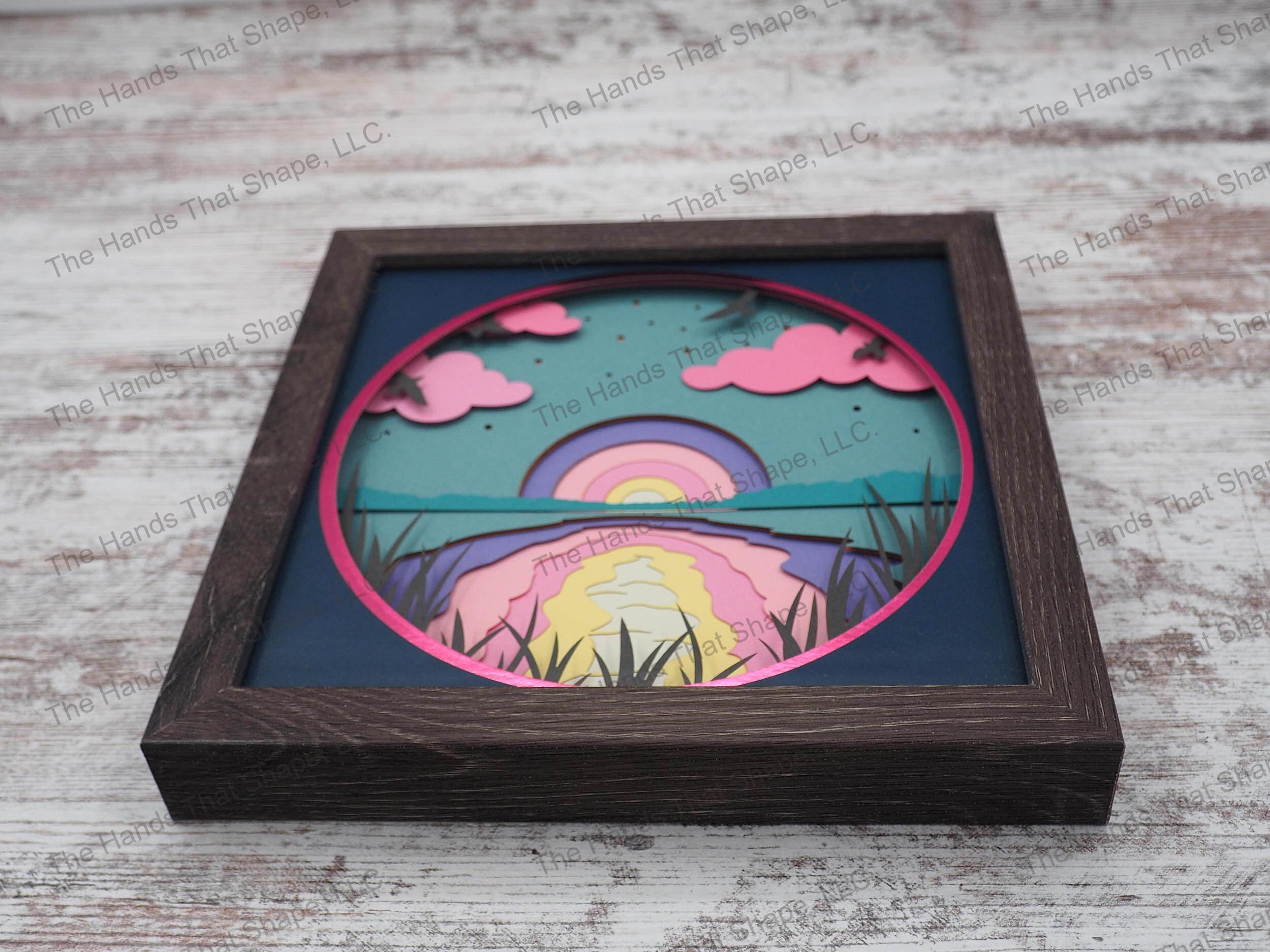 The shadow box features the setting sun about to pass over the horizon creating such a majesty of colors dancing over the water and clouds.