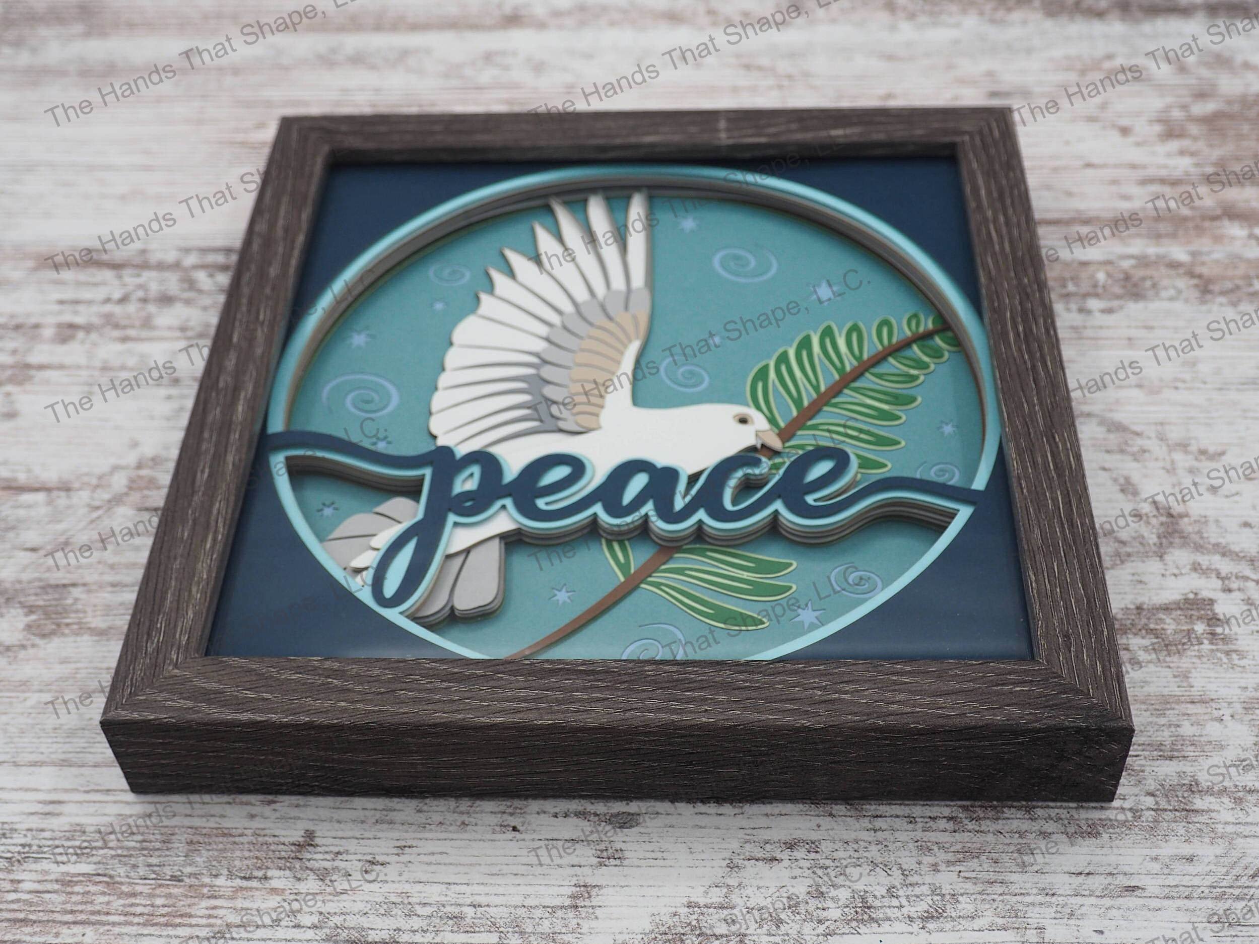 The “Peace” shadow box features a dove holding an olive branch as a reminder to add more tranquility to our lives.