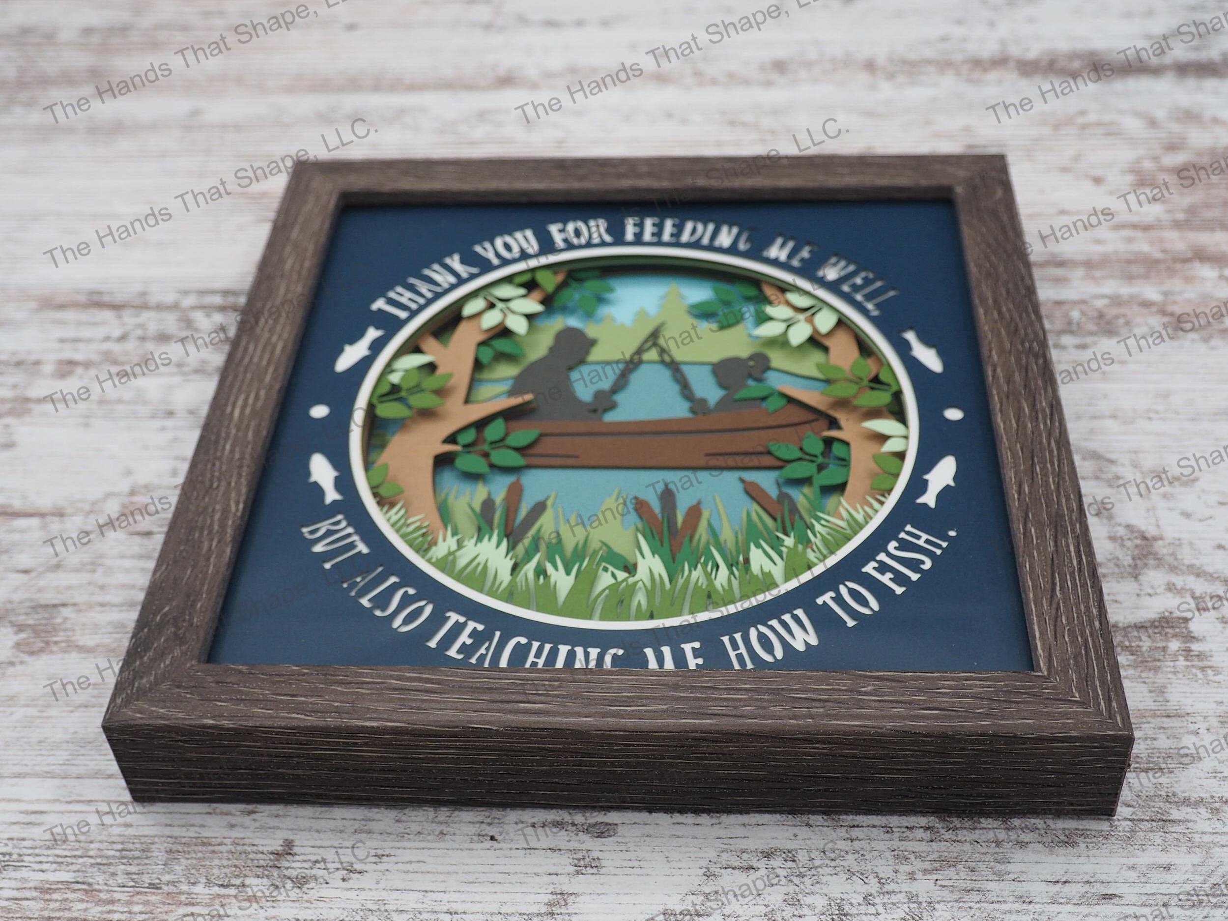 The shadow box features a boy or girl silhouette with a father figure enjoying a day fishing out on the lake or pond along with words of thanks.