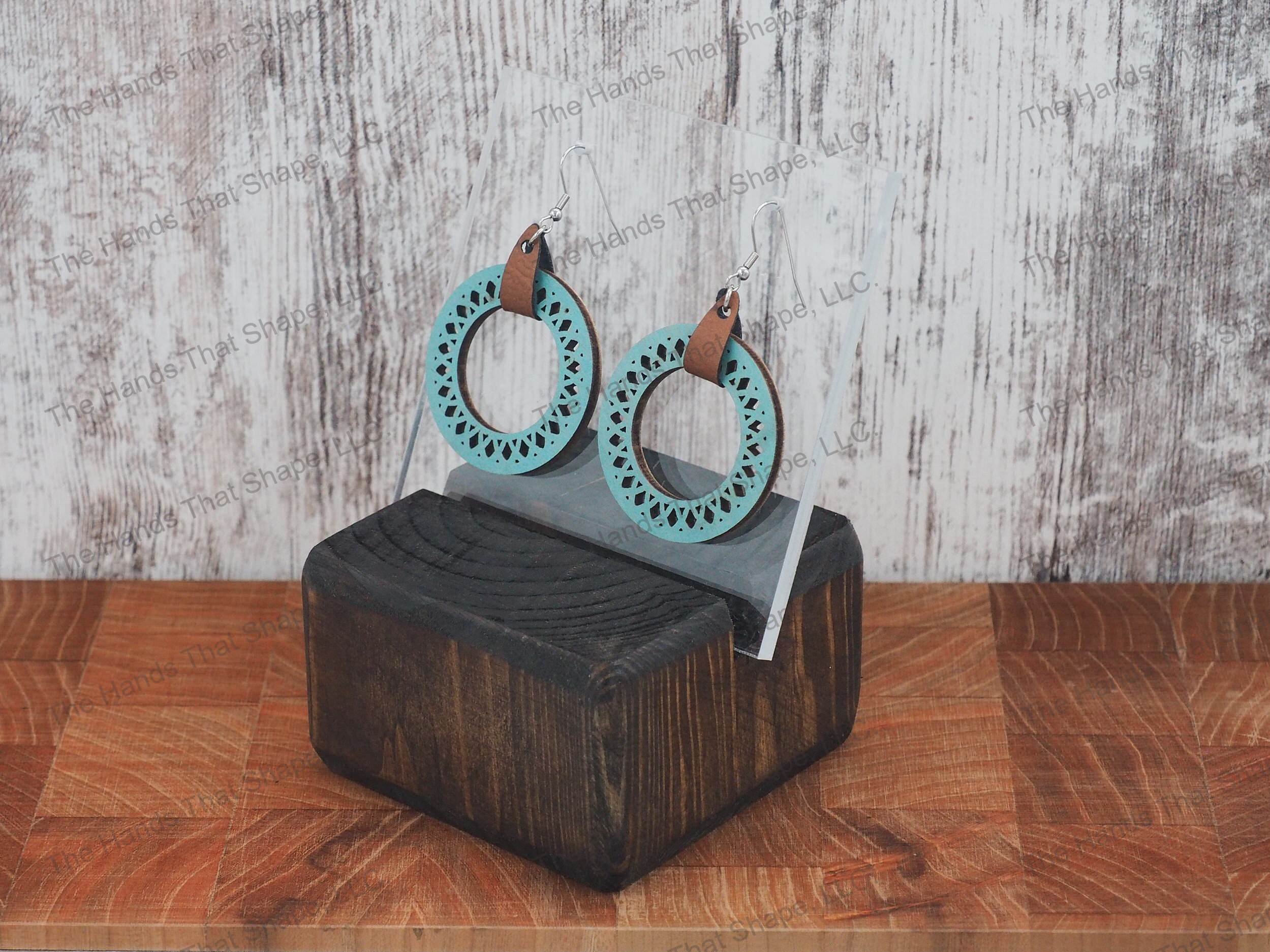 The Round Filagree earring features a dainty filagree cutout from a blue wooden hoop.