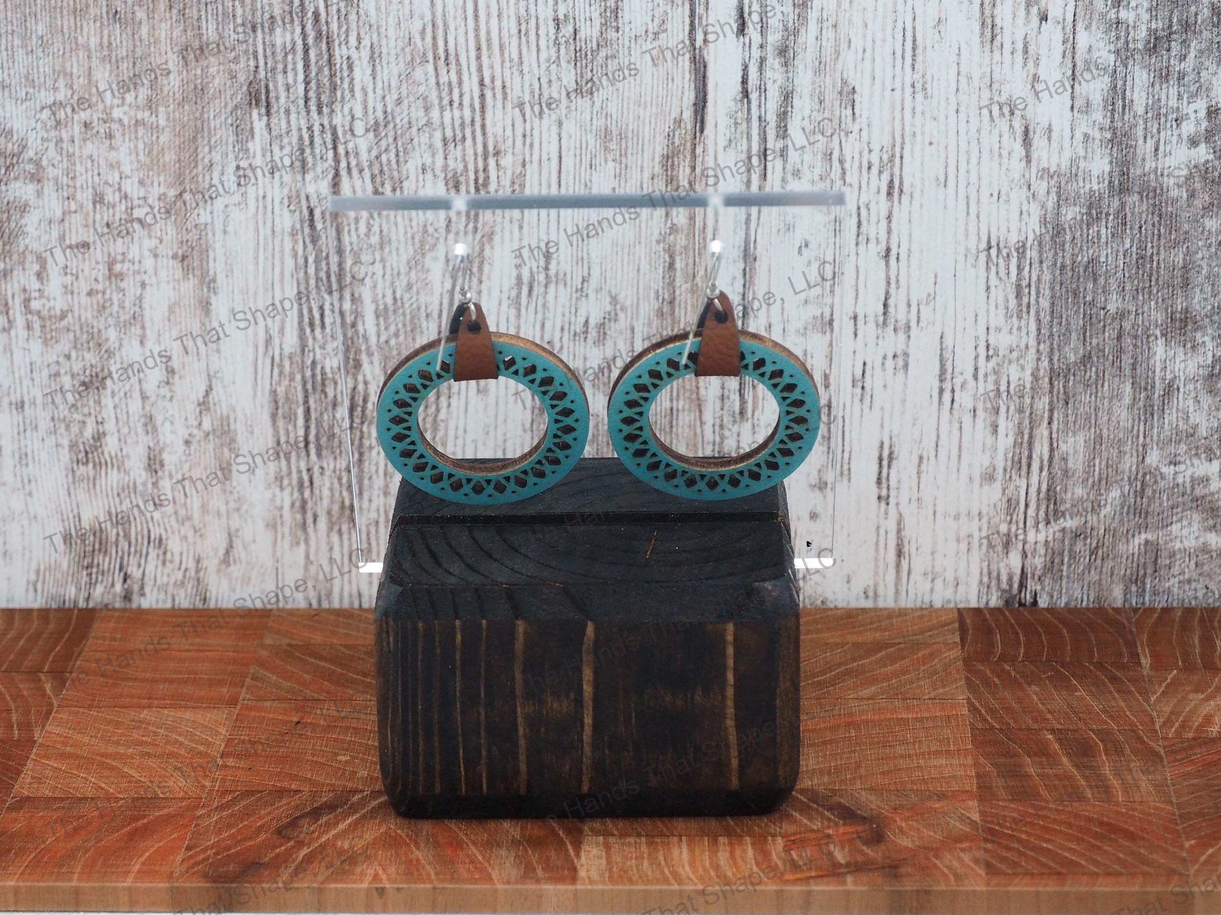 The Round Filagree earring features a dainty filagree cutout from a blue wooden hoop.