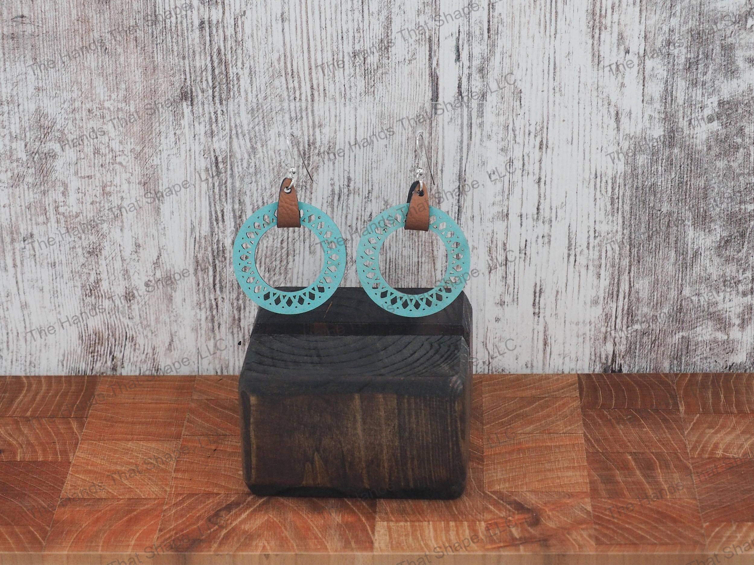 The Round Filagree earring features a dainty filagree cutout from a blue wooden hoop.