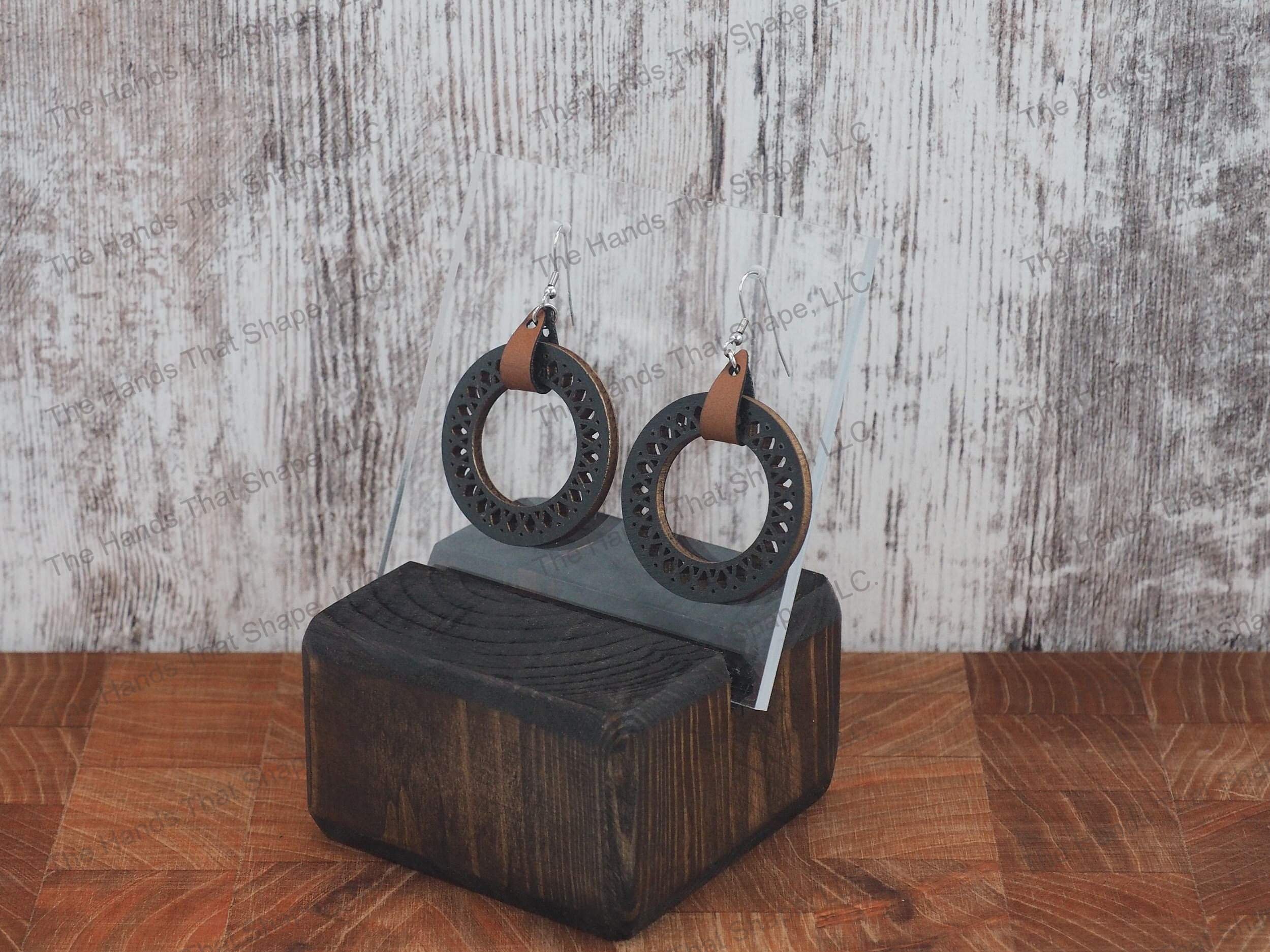 The Round Filagree earring features a dainty filagree cutout from a black wooden hoop.