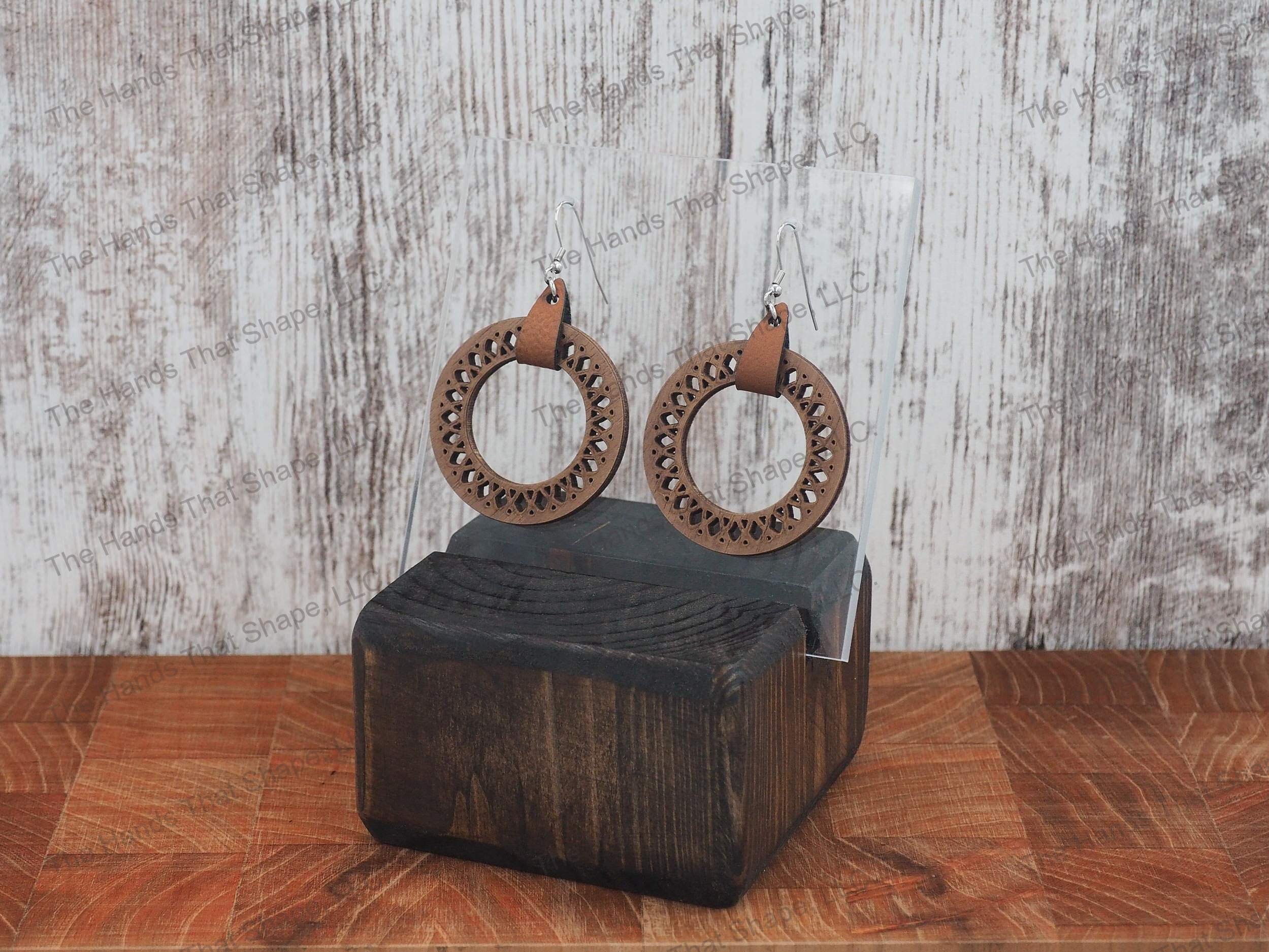 The Round Filagree earring features a dainty filagree cutout from a brown wooden hoop.