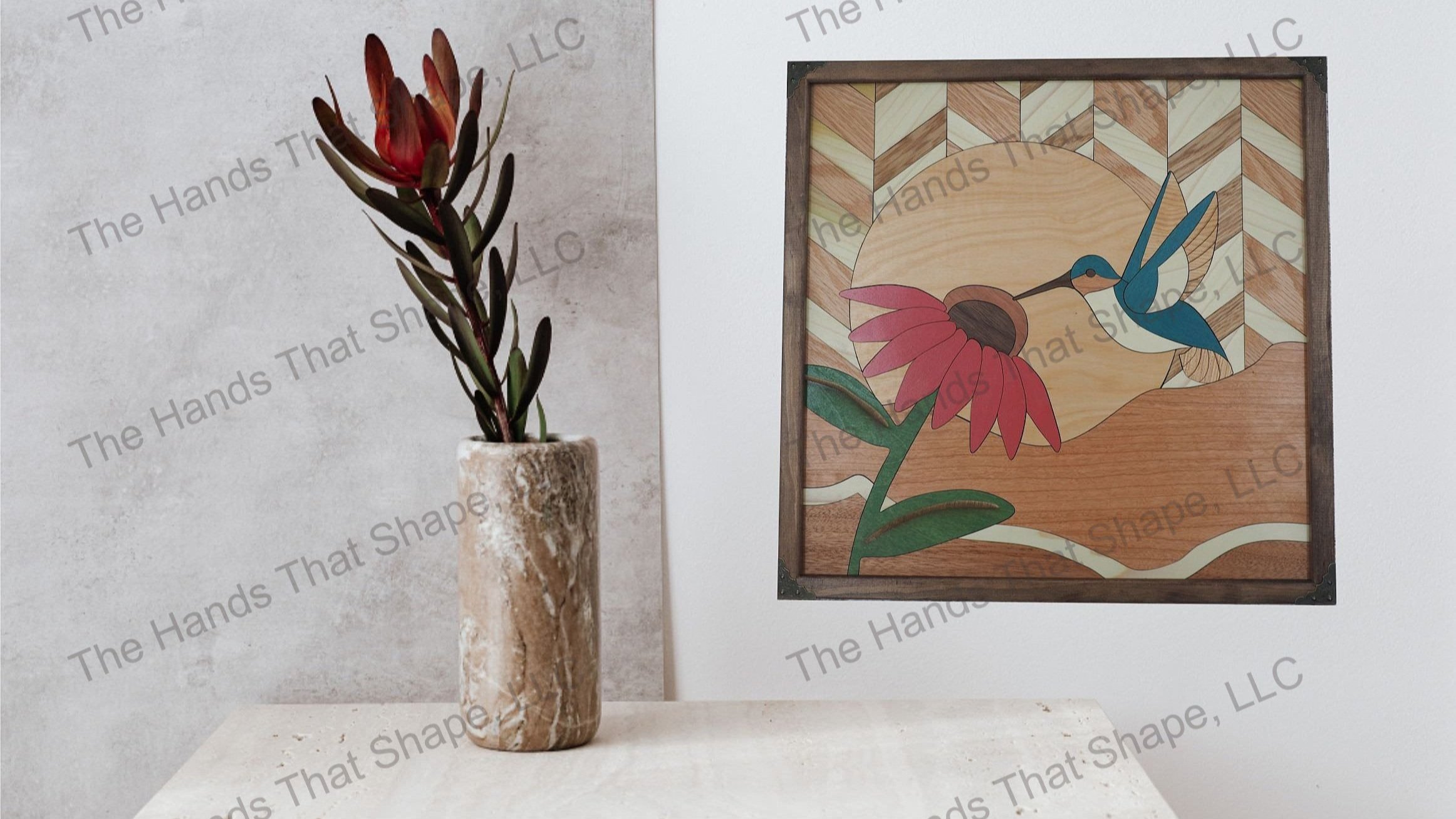 View the finished Coneflower and Hummingbird wood wall art, beautifully showcased above a flower vase on a shelf in a living room for all to enjoy.