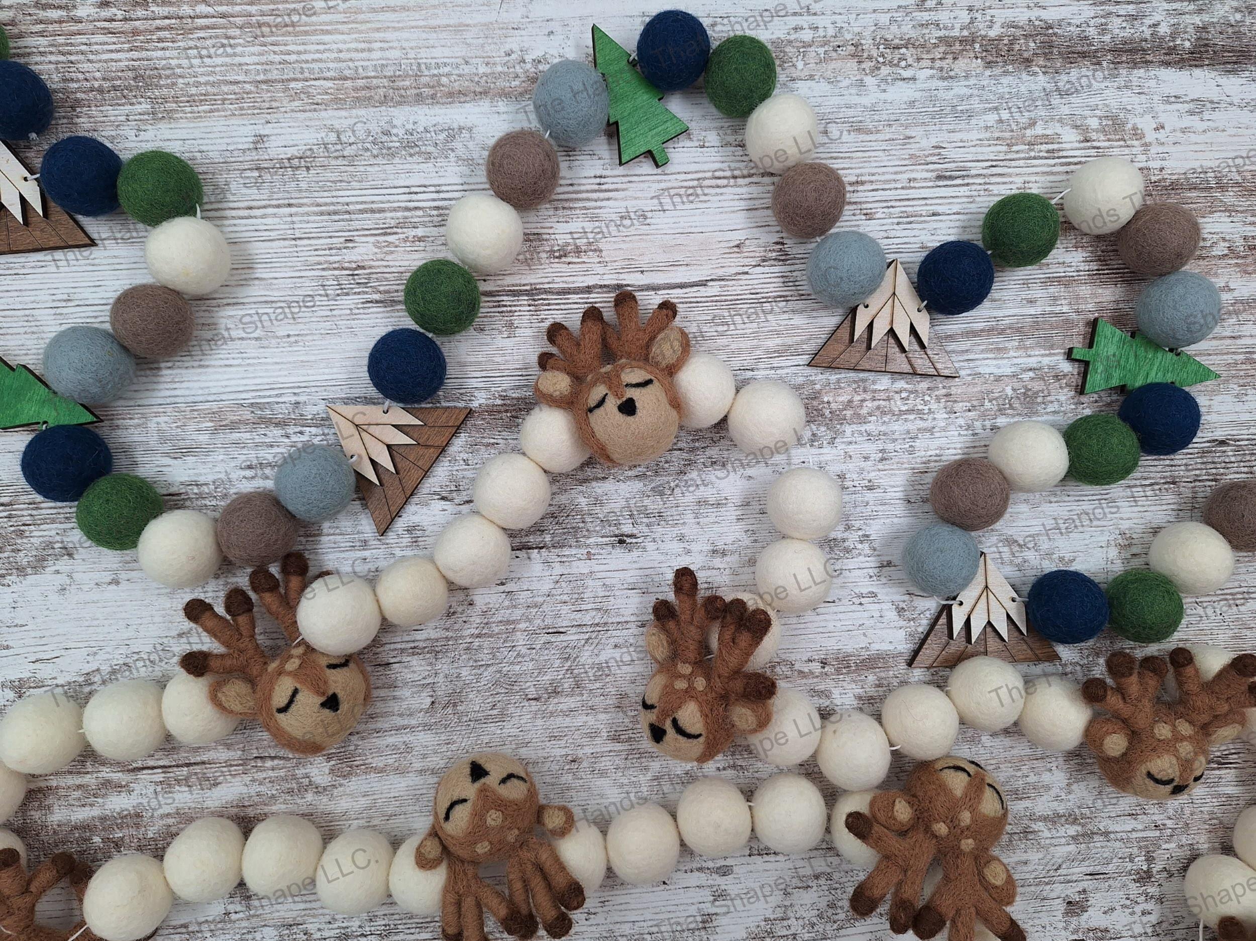 Examples of possible Felted Wool Pom Pom Garlands White with (E) Reindeer embellishment , Earth with (O) mountain and (P) tree embellishments