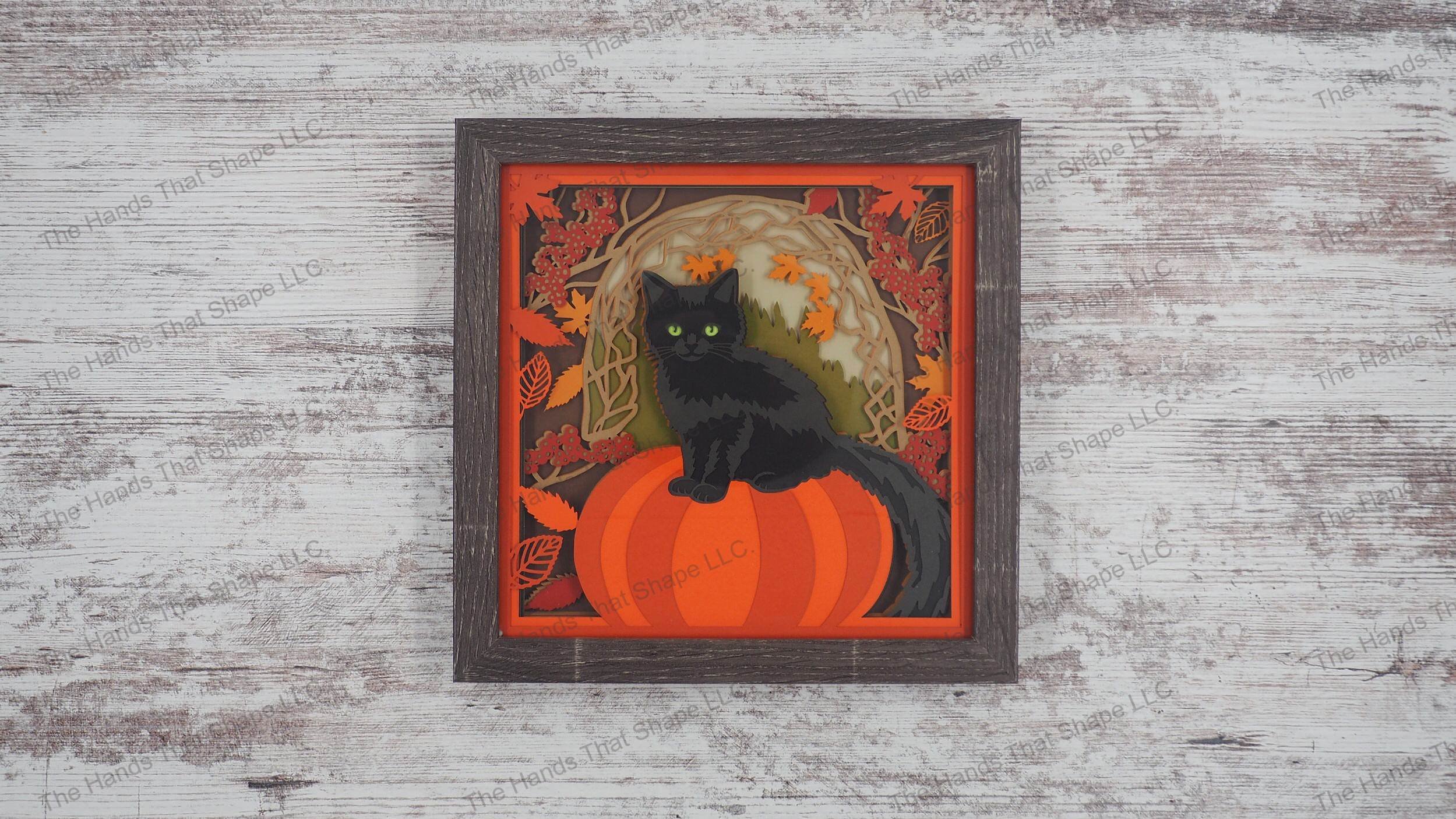 Autumn-themed 'Fall Cat on Pumpkin' shadowbox with 12 cardstock layers, featuring a black cat, pumpkin, and falling leaves in a gray MDF frame.