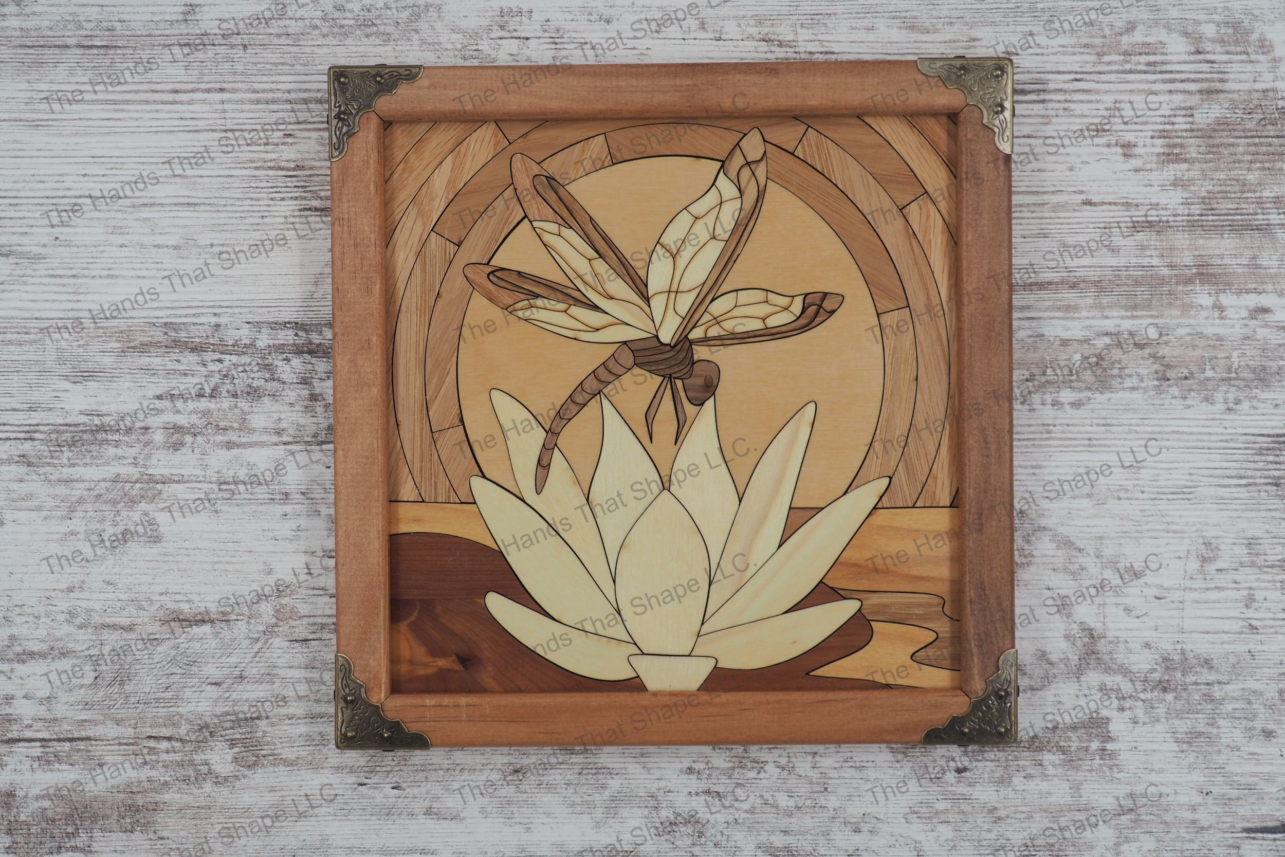 Experience the serene elegance of "Dawn's Whispers: Dragonfly on Water Lily" wood inlay wall art that captures a tranquil dragonfly on a water lily at sunrise.