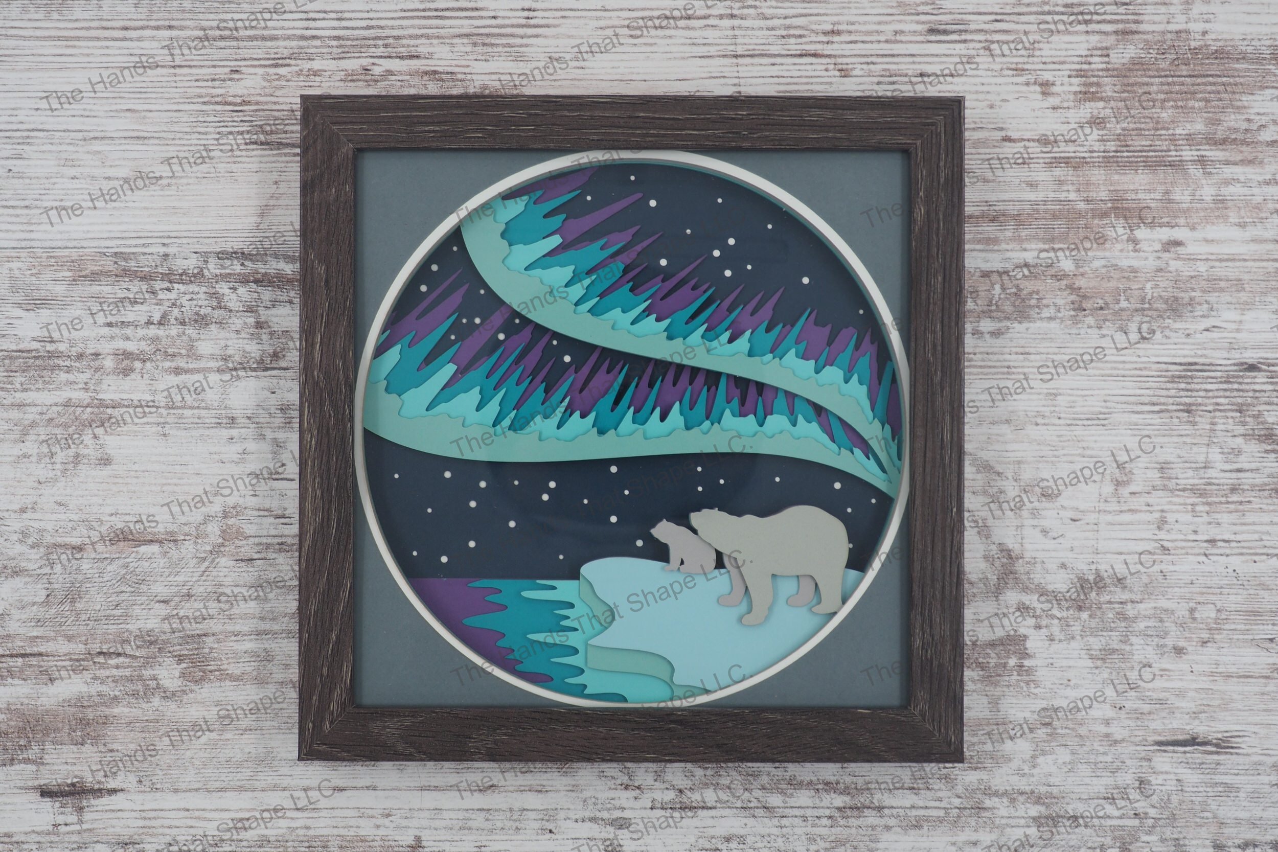 The “Bear & Northern Lights” shadowbox is made up of layers of premium cardstock and features a mama bear and cub gazing at the mesmerizing northern lights.