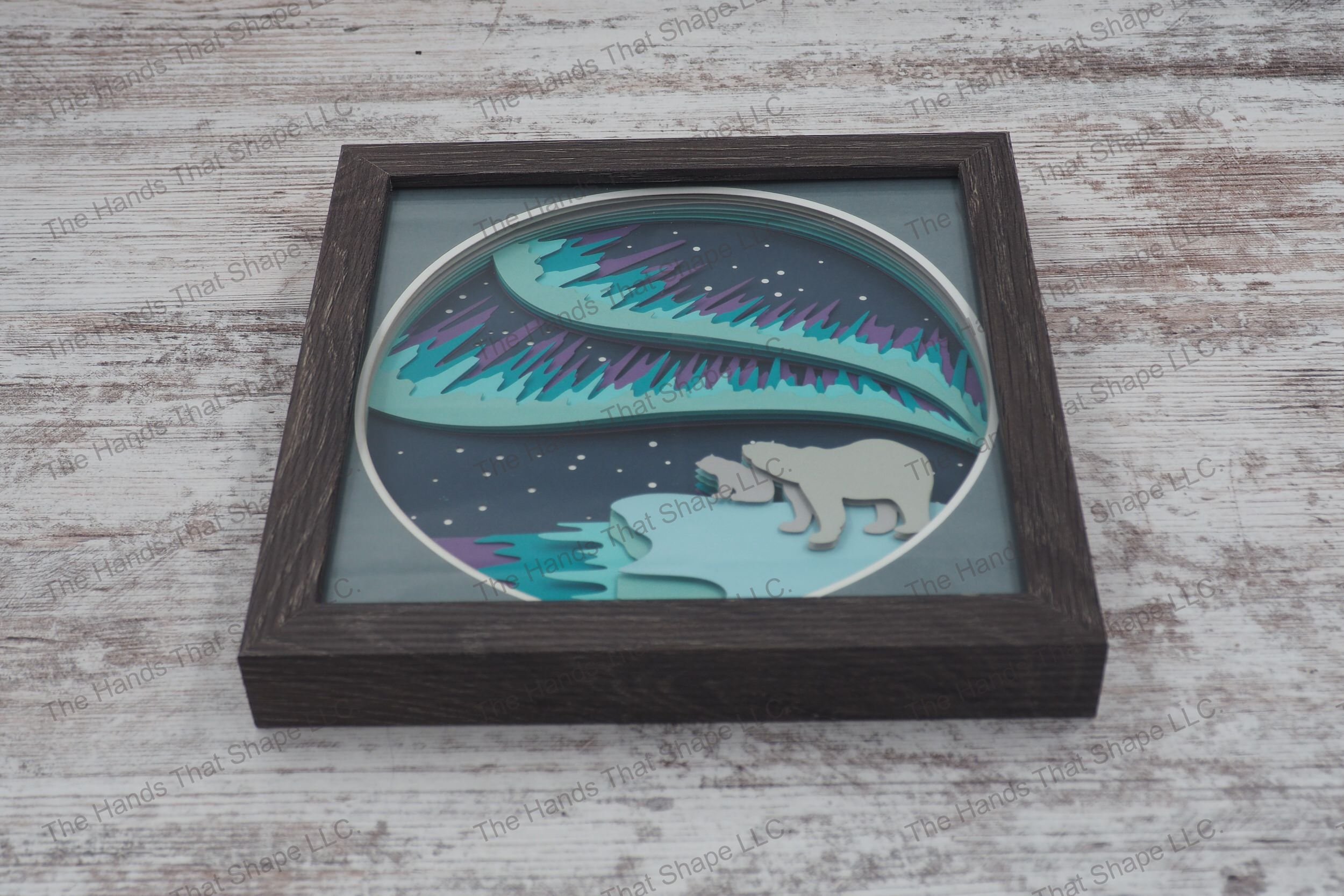 The “Bear & Northern Lights” shadowbox is made up of layers of premium cardstock and features a mama bear and cub gazing at the mesmerizing northern lights.