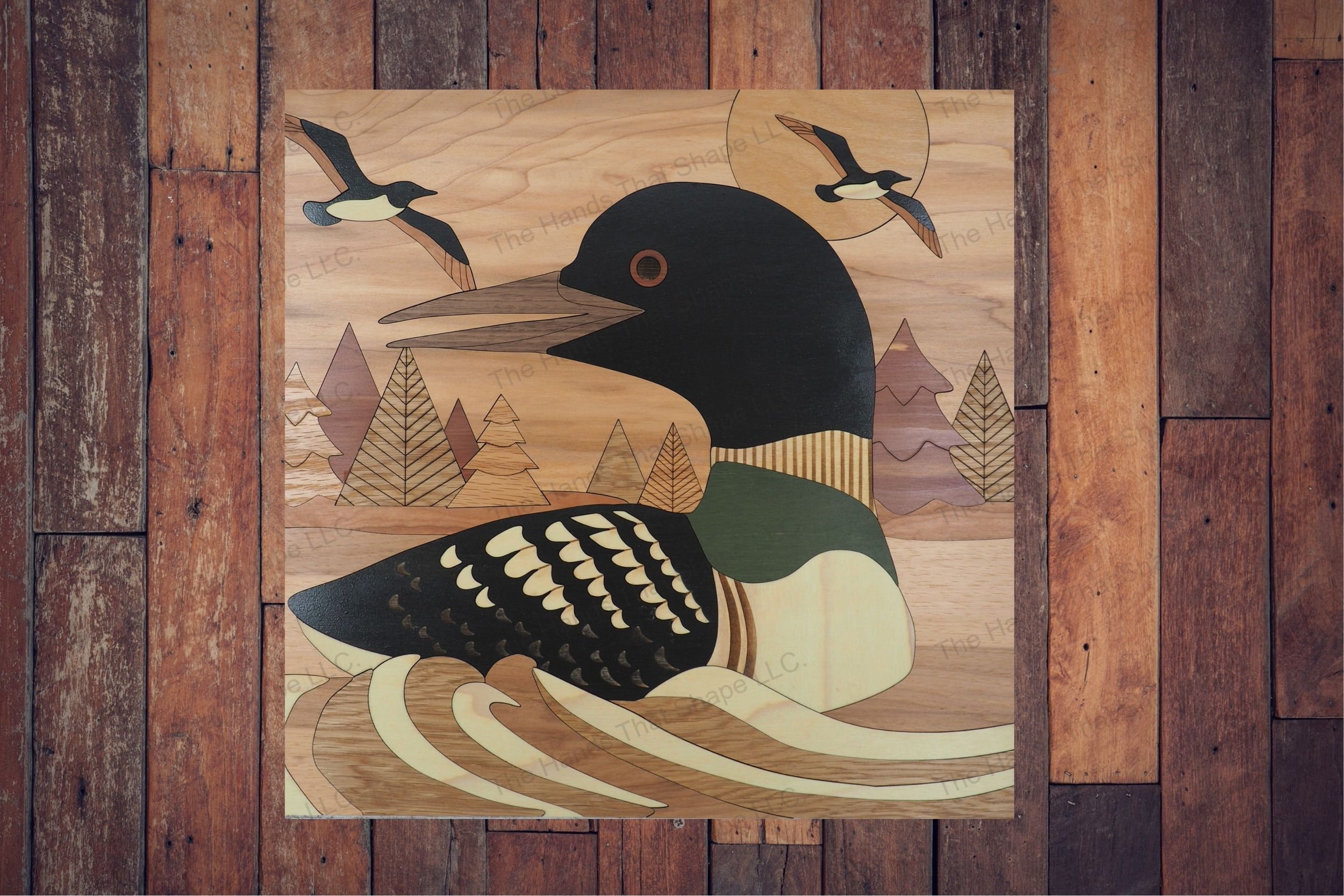 With our laser ready file craft a serene wood inlay art featuring a loon on the lake, detailed with score lines and engravings, perfect for all skill levels.