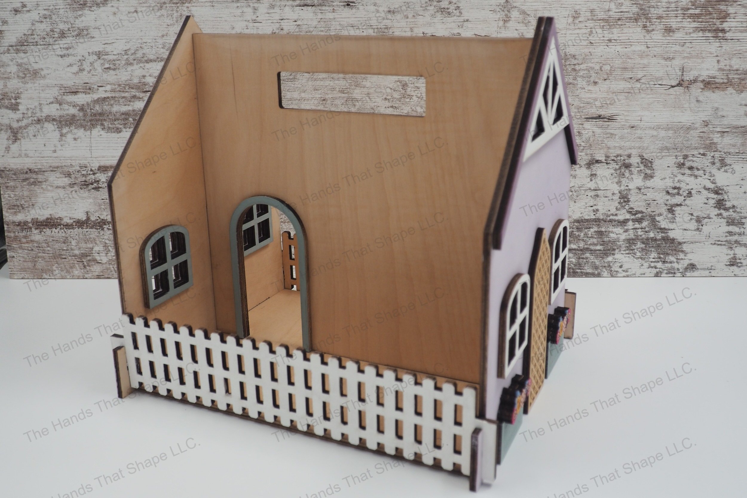 Craft a magical portable wooden dollhouse with our laser-ready design file, featuring detailed decorations, an easy-carry handle, and tab and slot assembly.