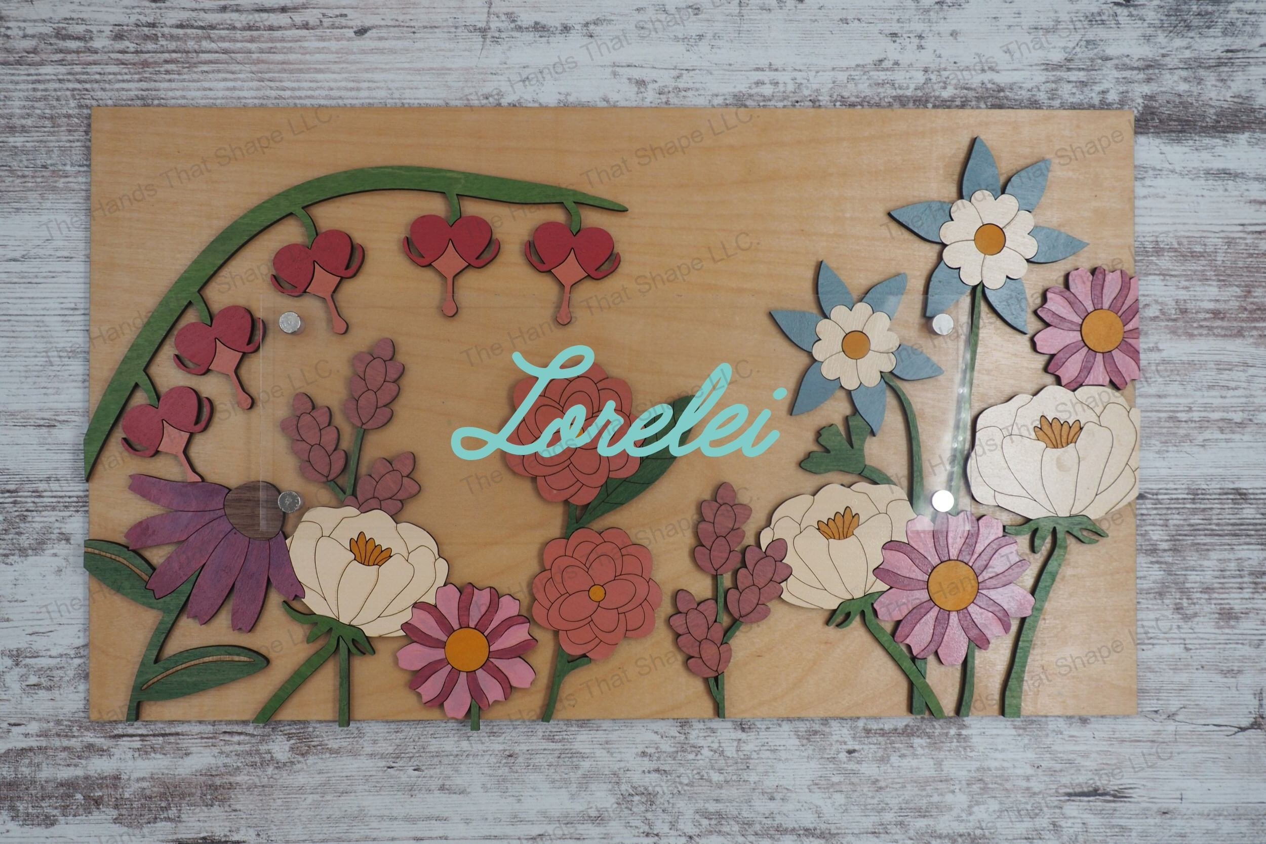 Craft exquisite layered floral signs with our laser-ready file, featuring a 69-piece wood inlay arrangement under a clear acrylic layer perfect for adding text.
