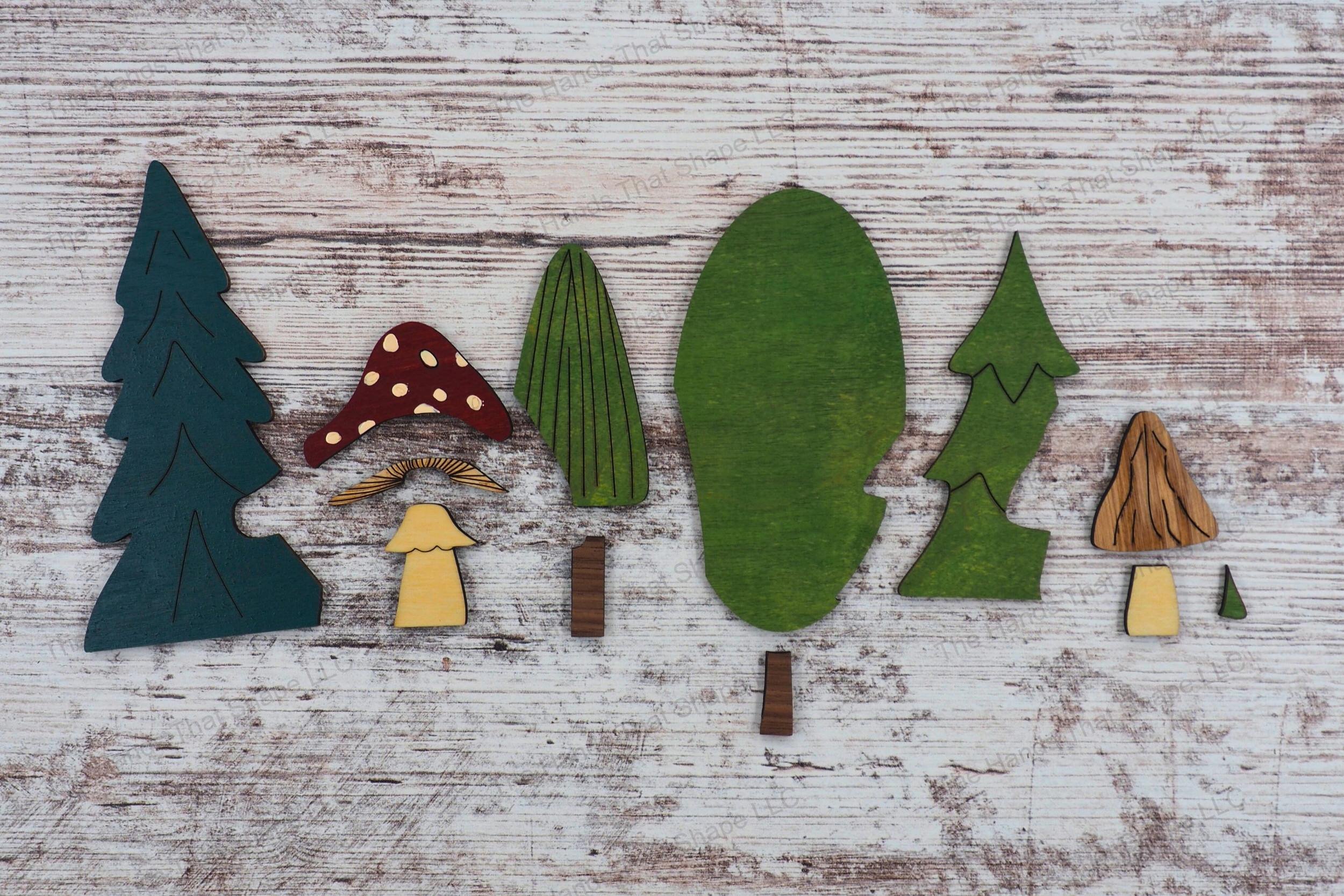 Explore the individual inlay pieces of our woodland playscape design file, ready to be assembled into a captivating forest and hillside house scene.