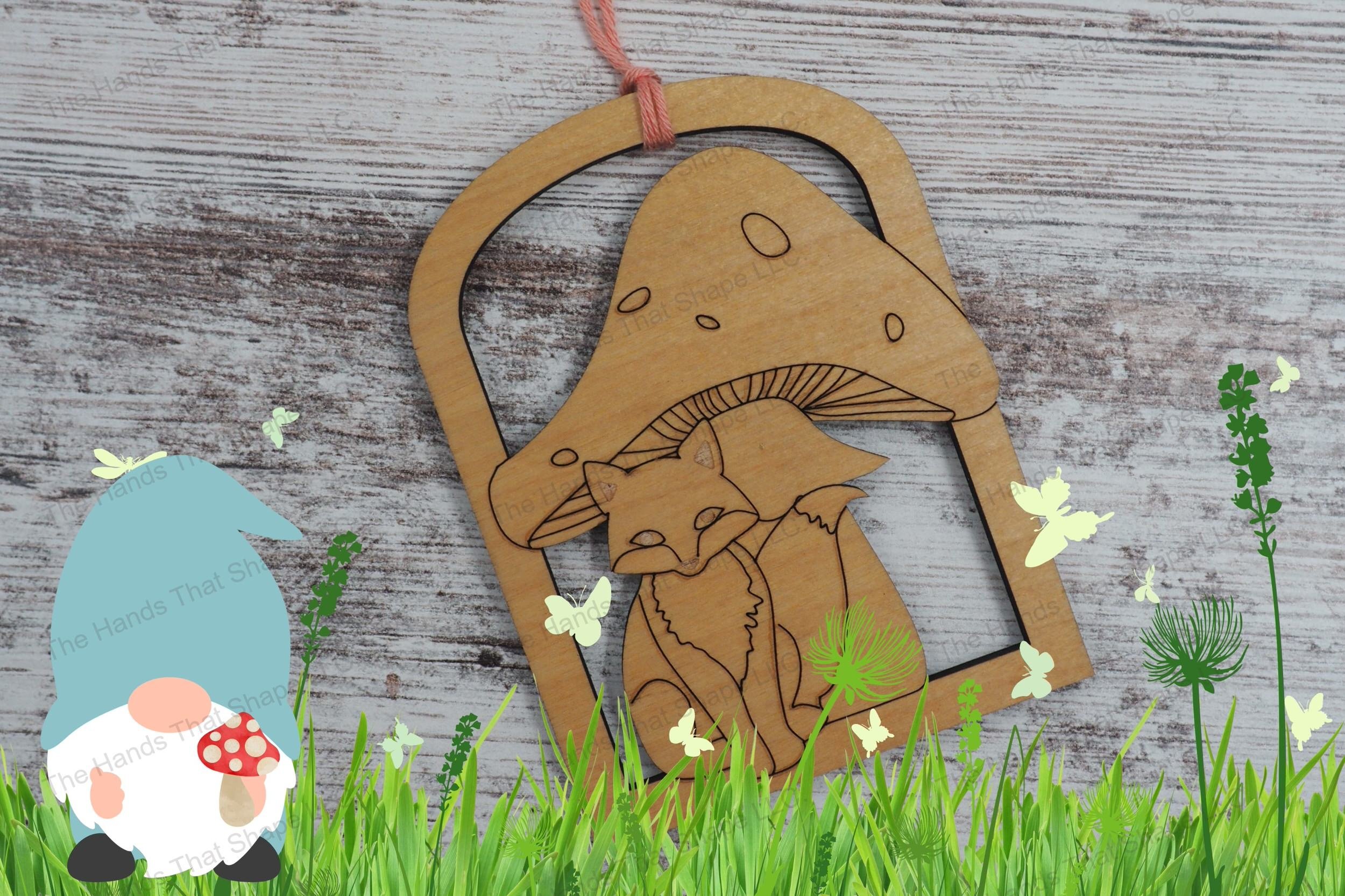 Create enchanting ornaments with our laser-ready design file featuring a fox sitting under a toadstool within an archway border, perfect for crafting gifts..