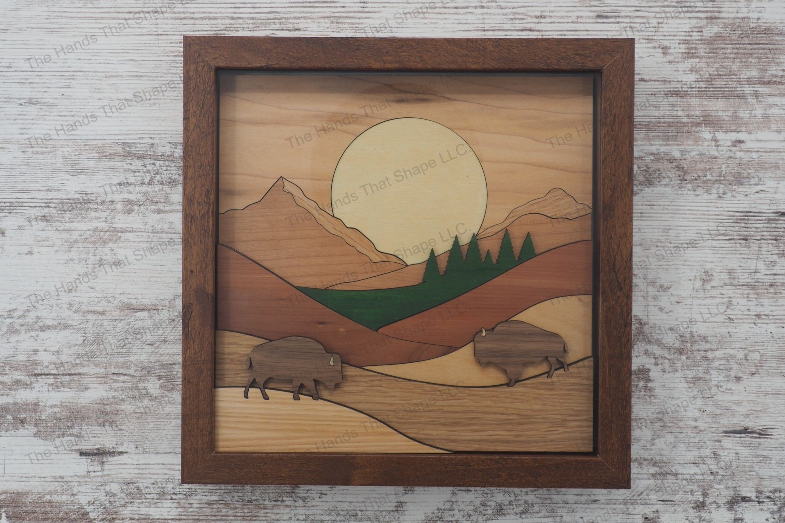 Craft a captivating 3D inlay art piece with our laser-ready design featuring two bison grazing on rolling hills, ideal for shadowbox displays or desktop decor.