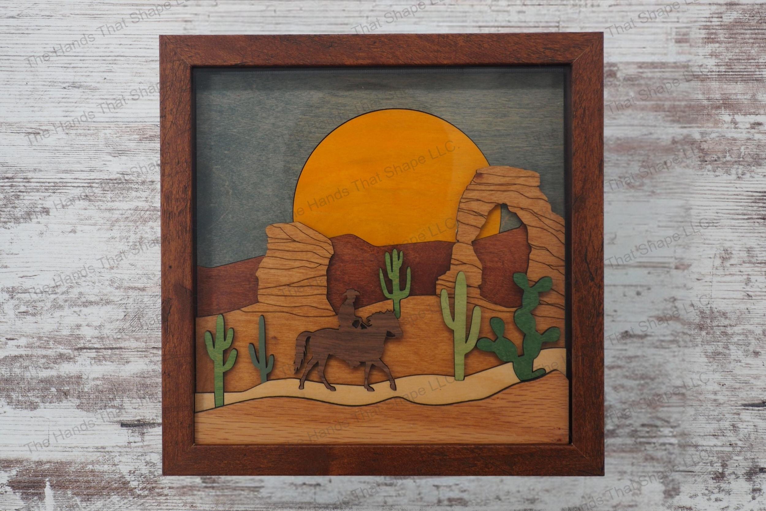 Create a captivating 3D inlay art piece with our laser-ready file featuring a lone cowboy in a desert landscape, perfect for shadowbox displays or desktop decor