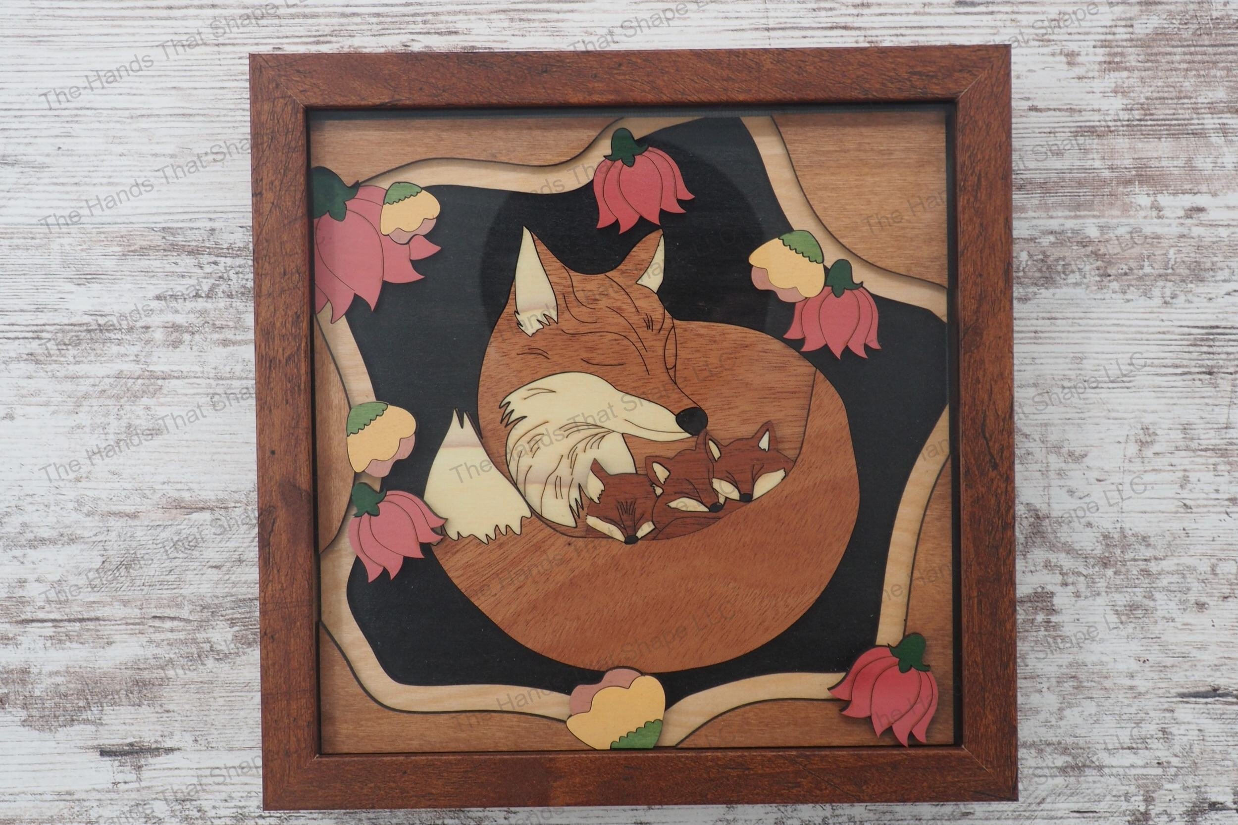 Craft a 3d wood inlay scene with our laser-ready design featuring a mother fox and her kits nestled among flowers, suitable for shadowboxes or desktop displays.