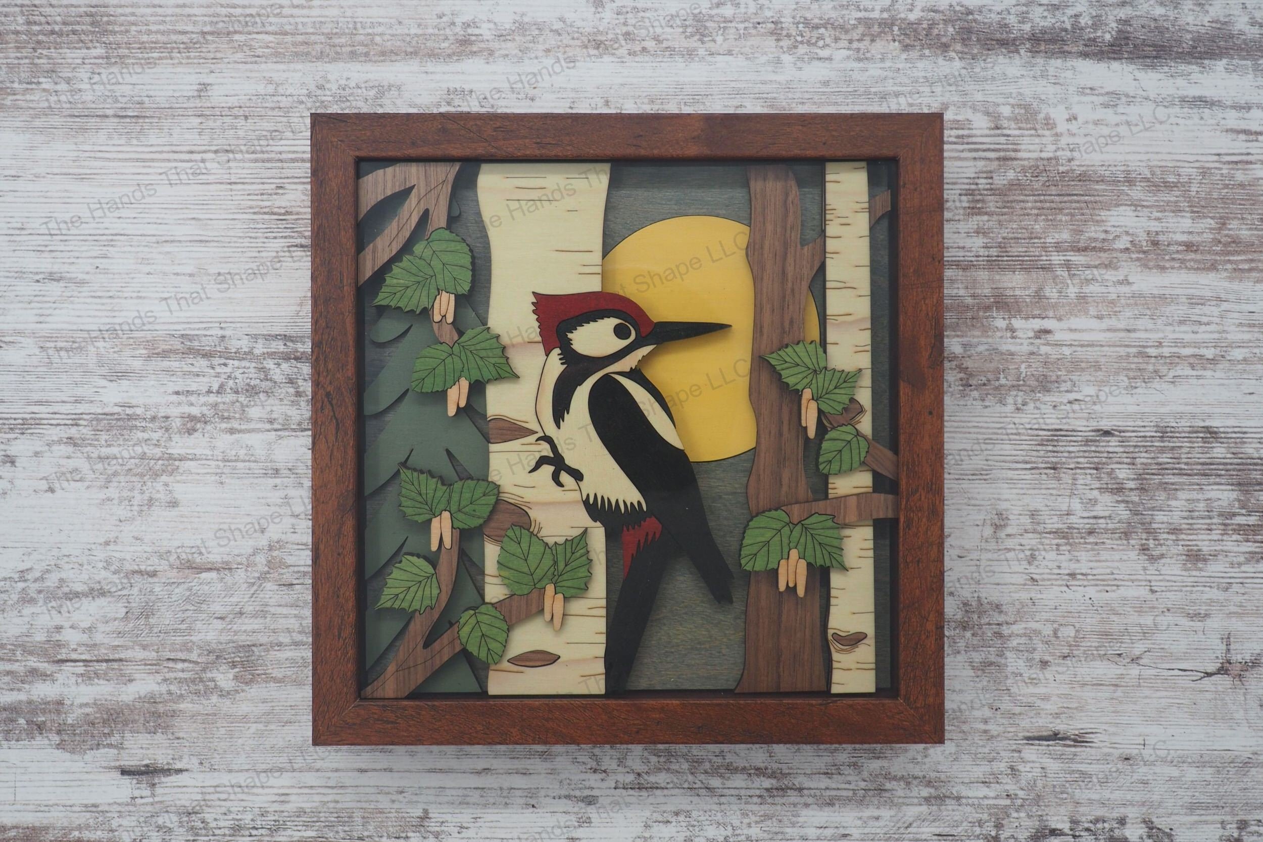 Create a stunning 3D inlay art piece with our laser-ready design featuring a woodpecker on a birch tree, perfect for adding a touch of nature to your home.