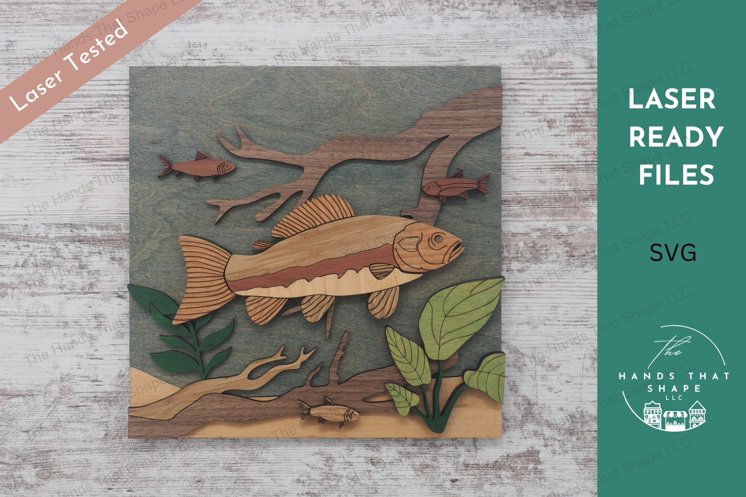 Craft a stunning 3D inlay art piece with our laser-ready design featuring a detailed trout amidst an underwater landscape with plants and branches.