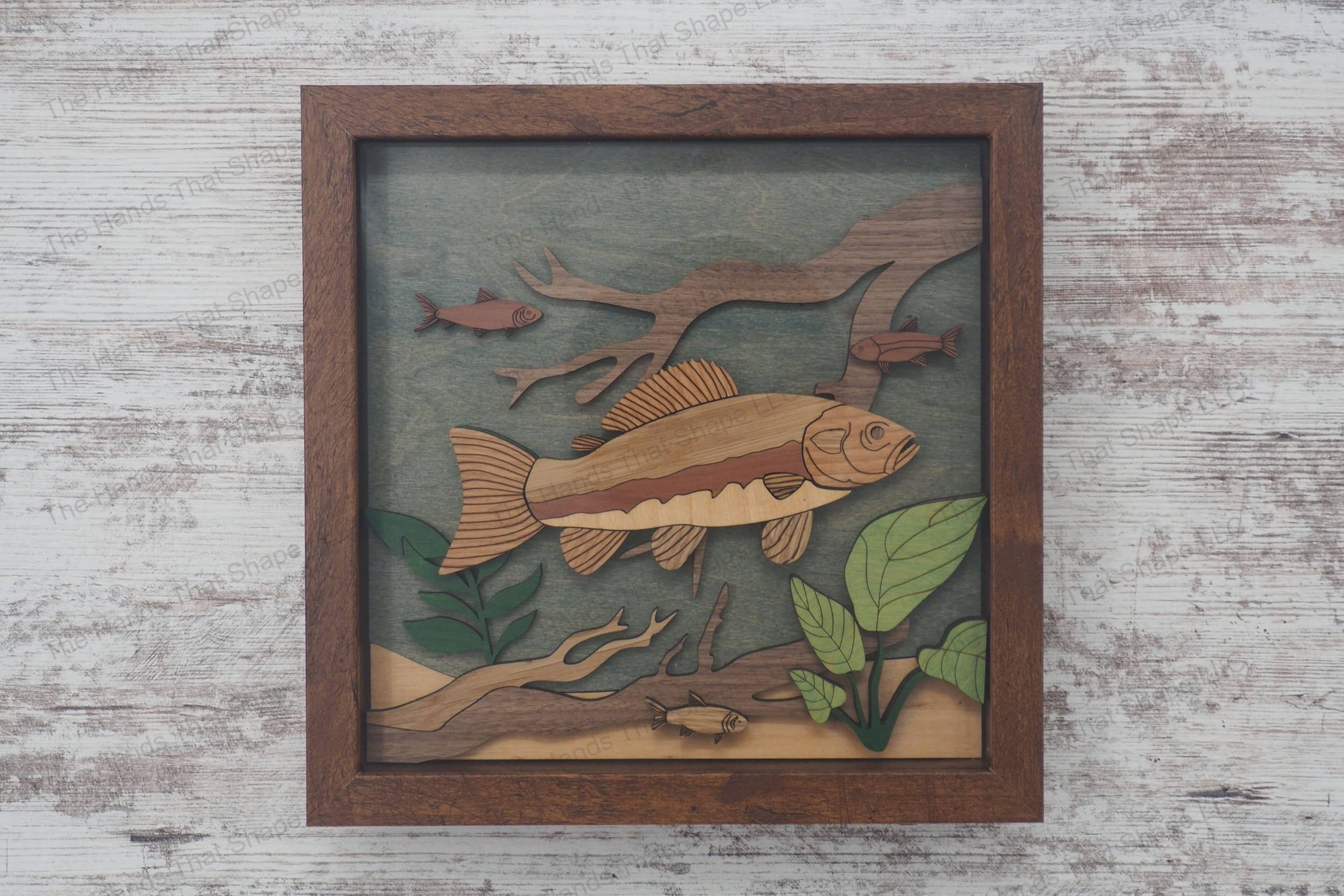 Craft a stunning 3D inlay art piece with our laser-ready design featuring a detailed trout amidst an underwater landscape with plants and branches.