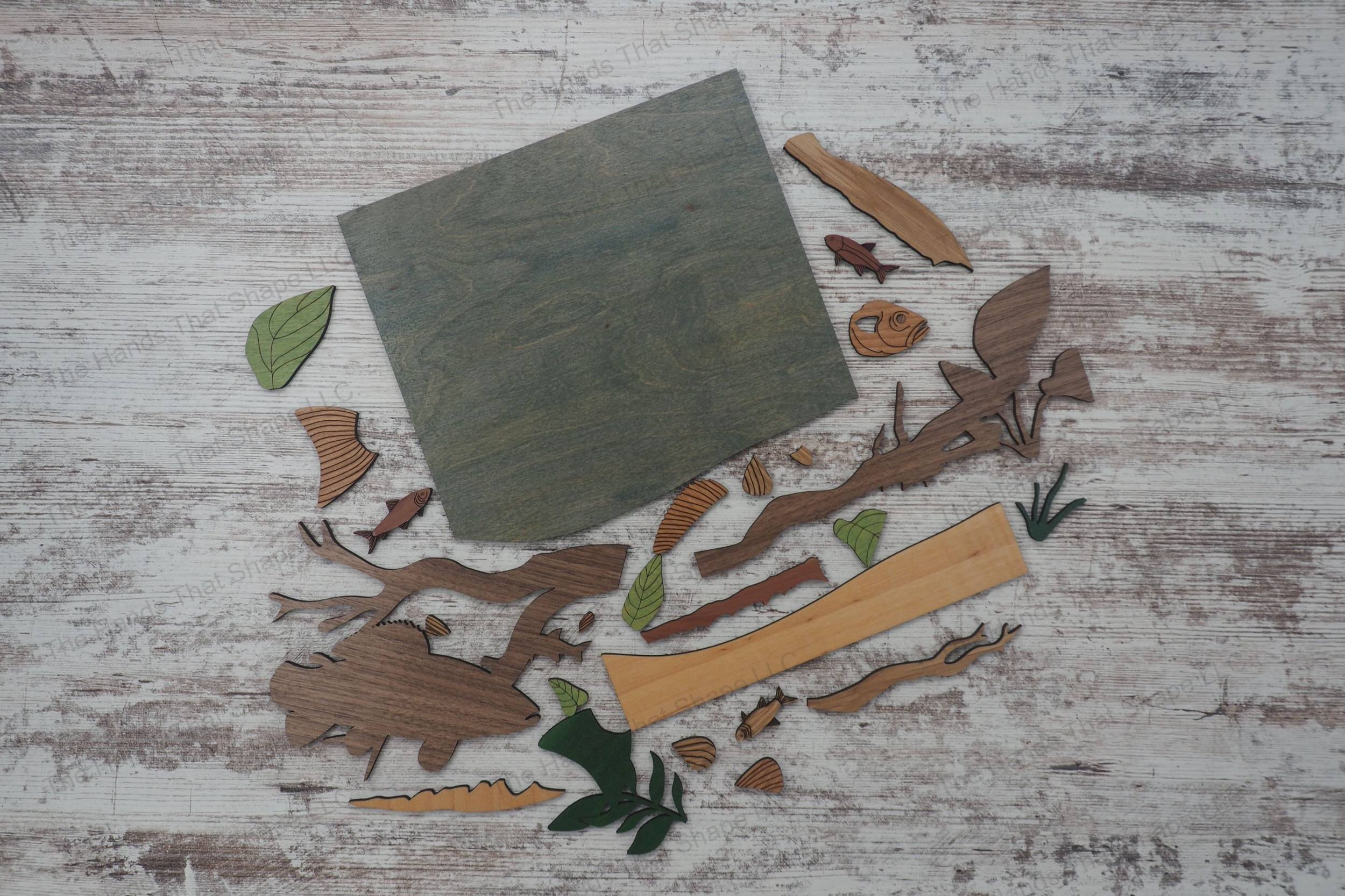 Craft a stunning 3D inlay art piece with our laser-ready design featuring a detailed trout amidst an underwater landscape with plants and branches.