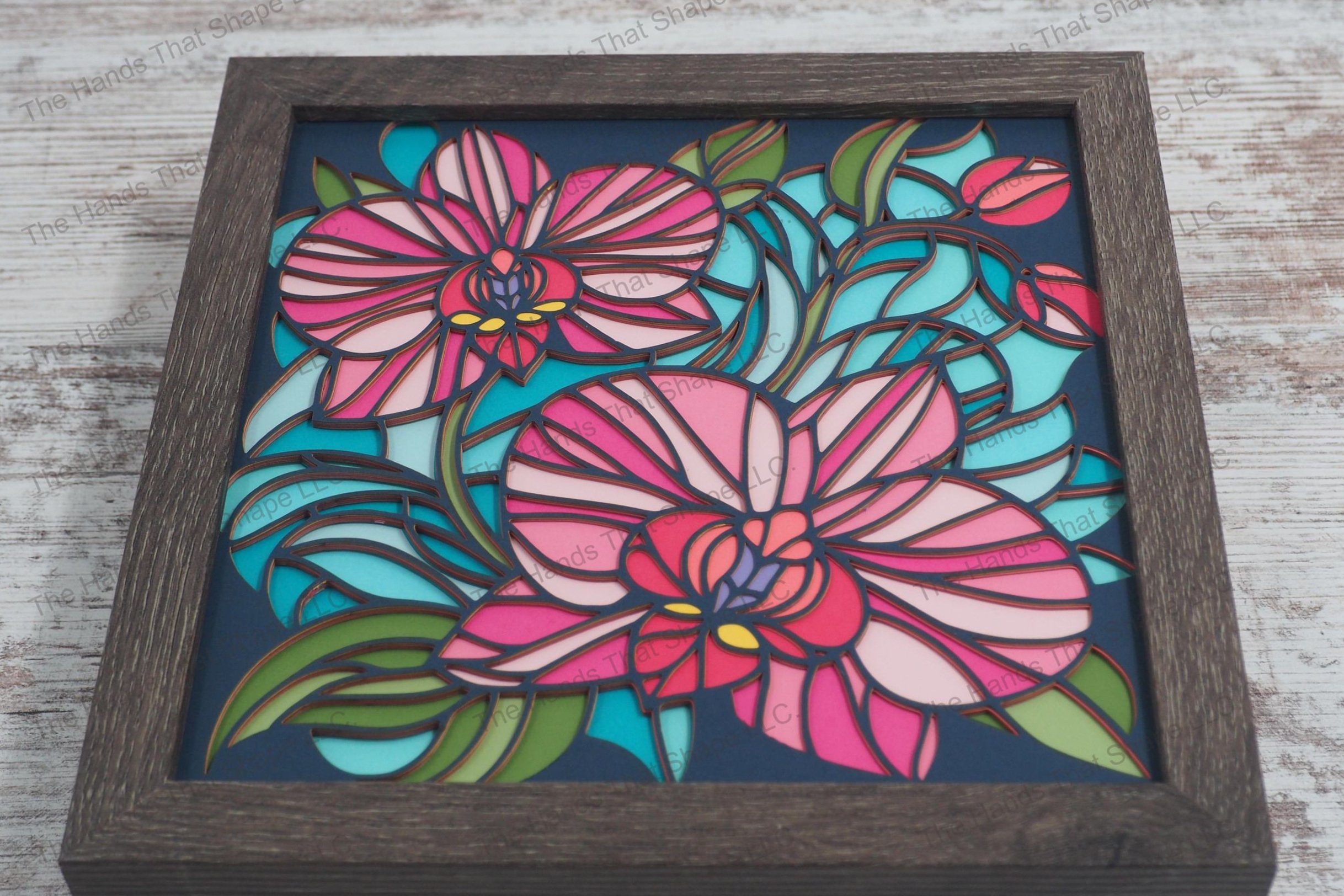Discover the delicate beauty of orchids with this layered paper shadowbox art, featuring two prominent orchid flowers and emerging buds set against lush leaves.