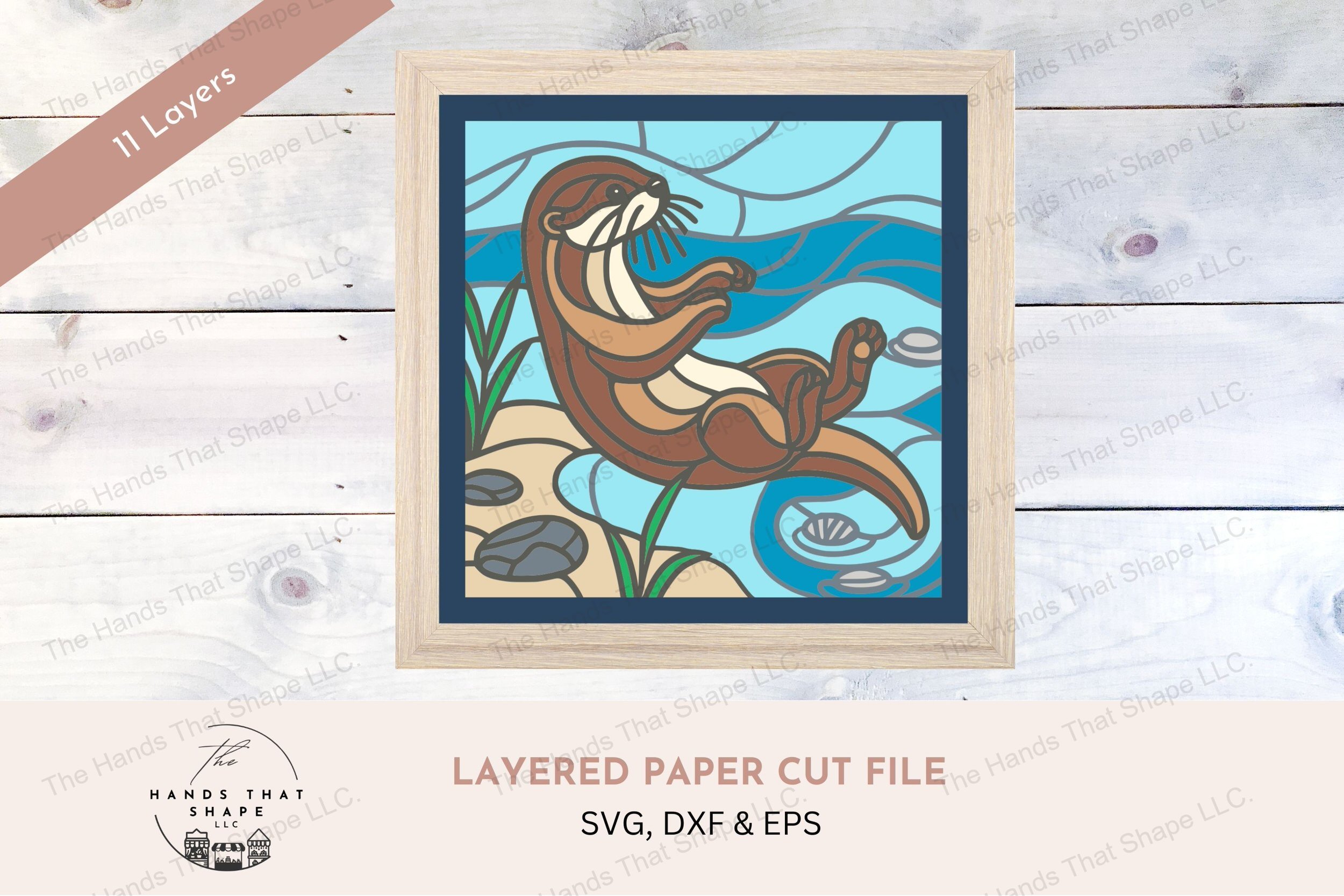 This layered cardstock art piece vividly captures a playful otter lounging by the water's edge, crafted with vibrant detail to bring the scene to life.