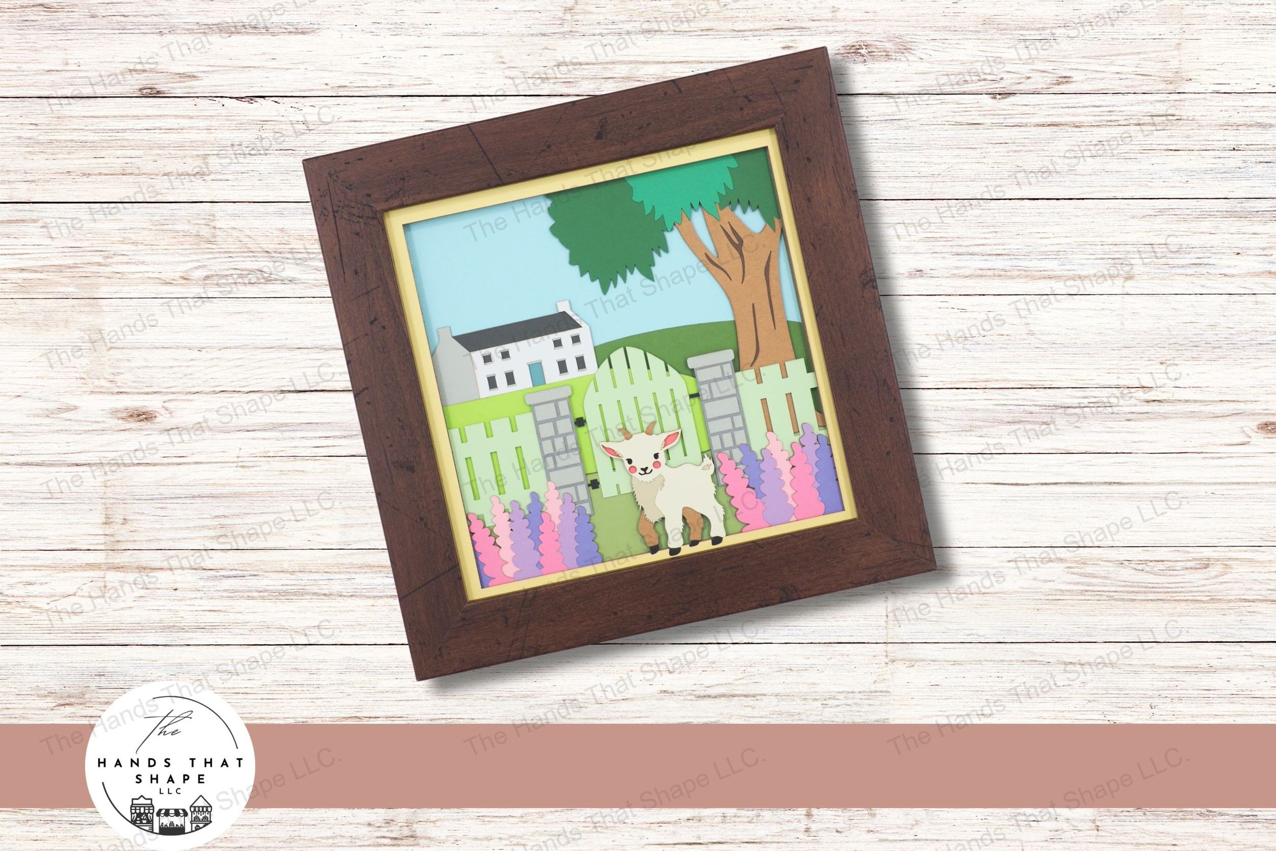 This layered paper art piece portrays a goat amidst hyacinth flowers, with a backdrop of a rustic fence, and grand house, creating a picturesque rural setting.