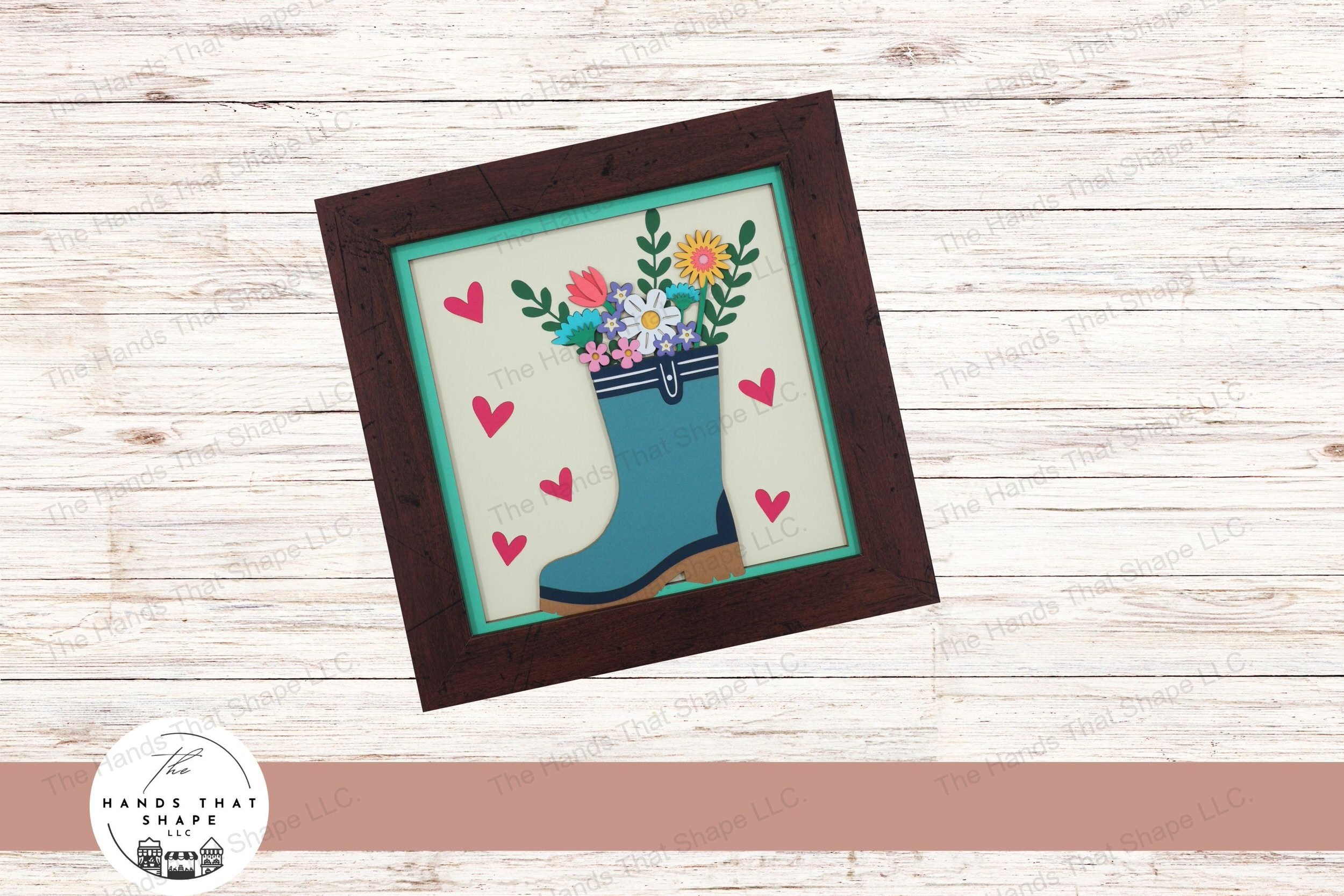 This layered cardstock art piece beautifully captures a colorful spring bouquet in a rainboot, creating a delightful and vibrant celebration of spring.