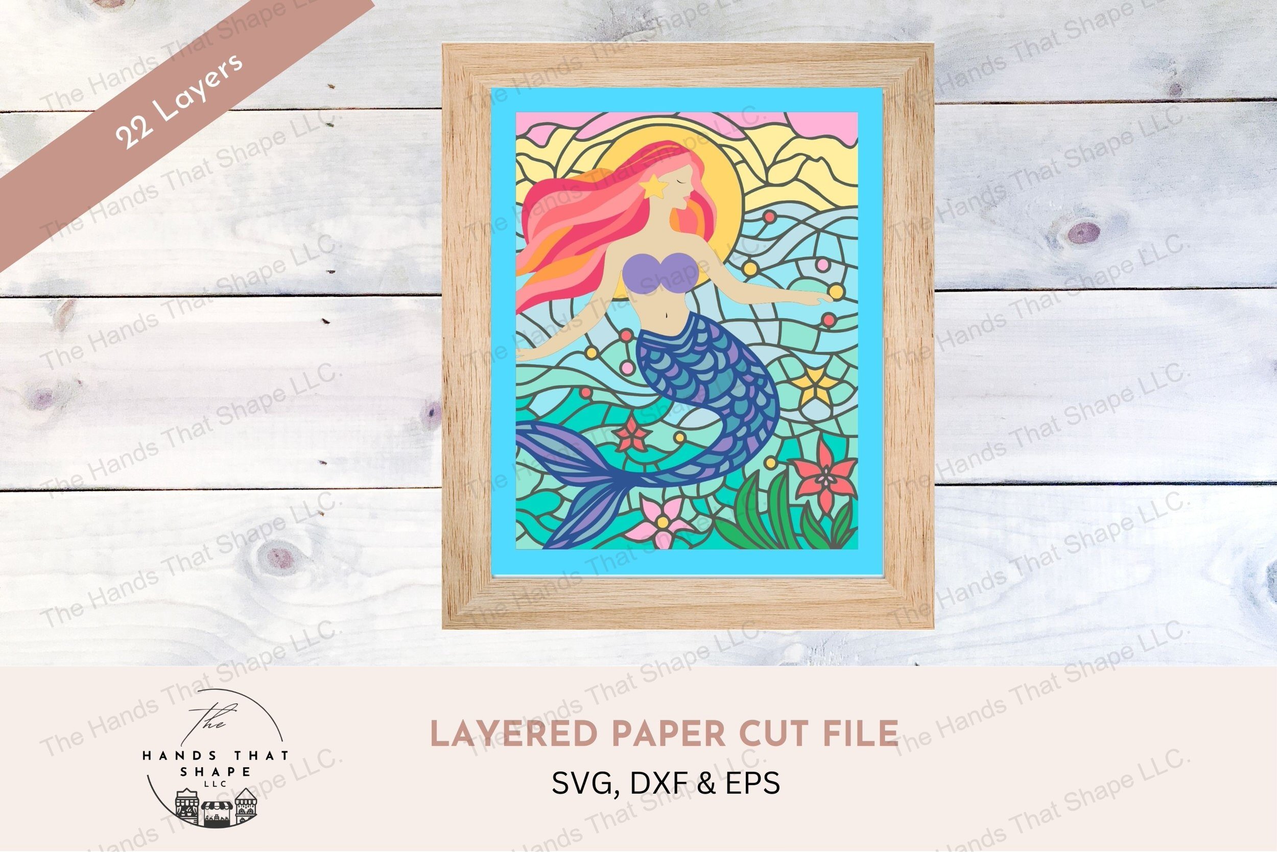 This layered cardstock art piece vividly captures a mystical mermaid with flowing hair, set against a backdrop of stained glass-style ocean blues and a sunrise.