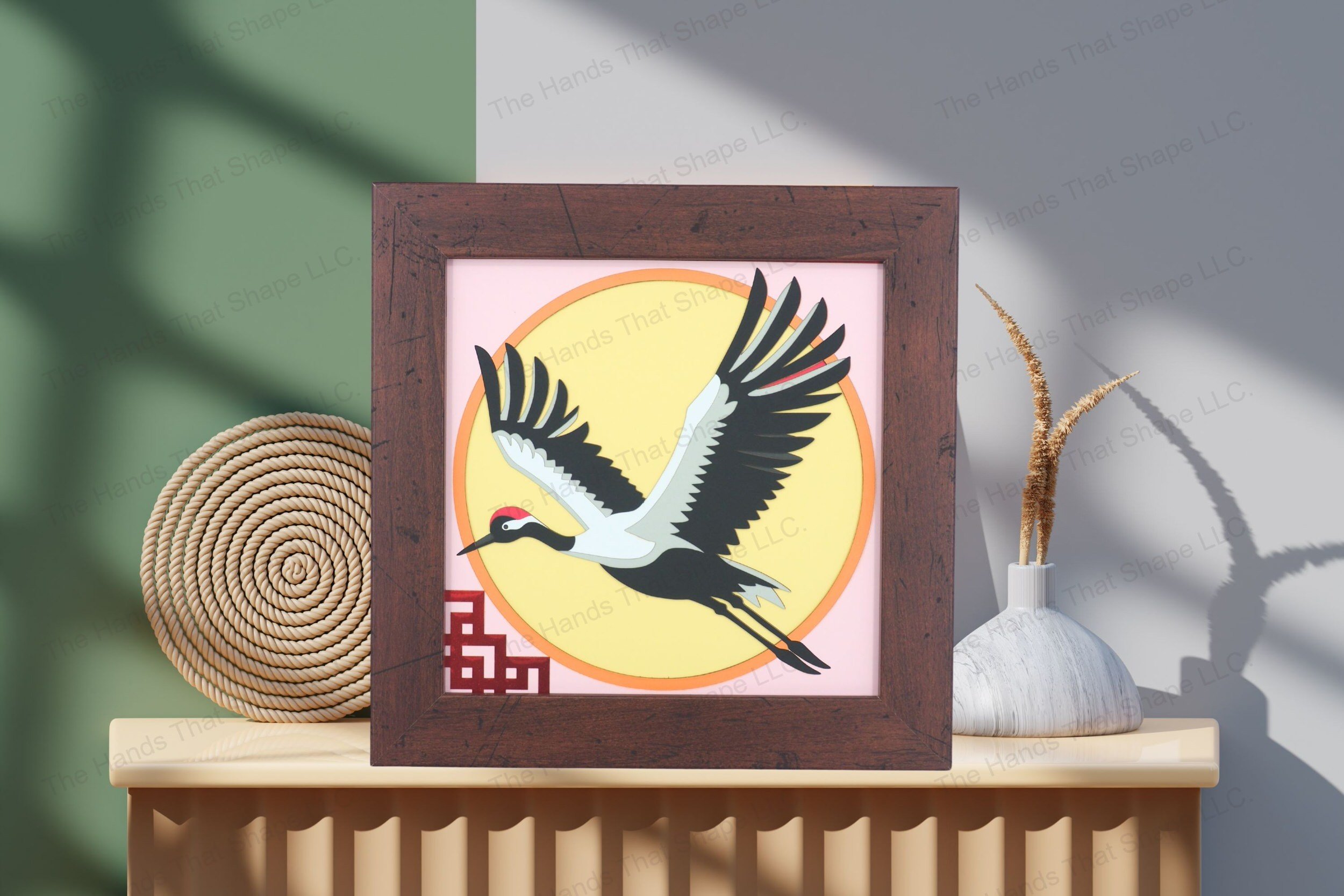 Admire this Japanese red-crowned crane cardstock artwork, beautifully displayed on a table, showcasing its layered depth and graceful, minimalist design.