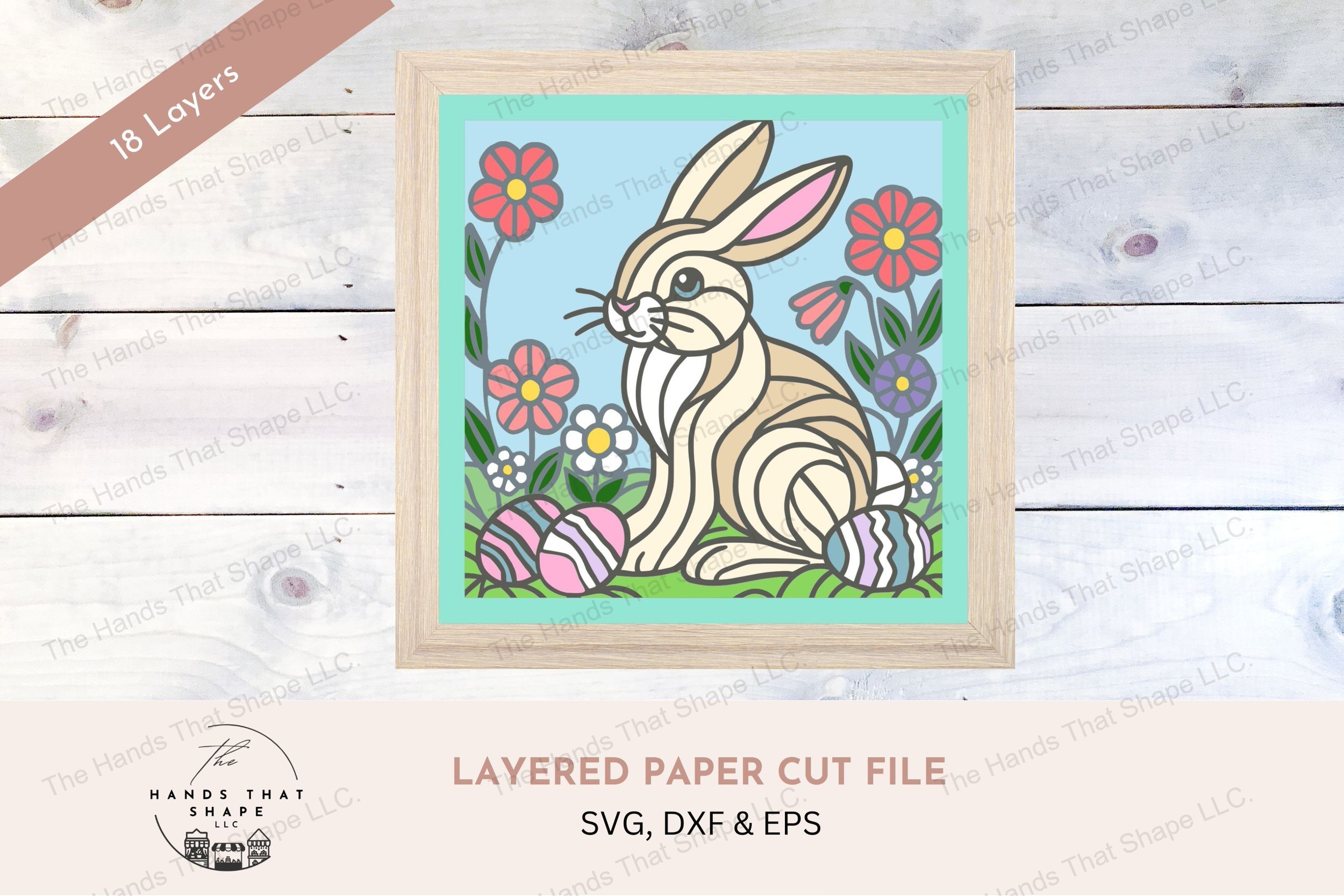 This layered cardstock art piece captures a charming Easter Bunny scene, featuring the bunny amidst colorful spring flowers and pastel eggs.