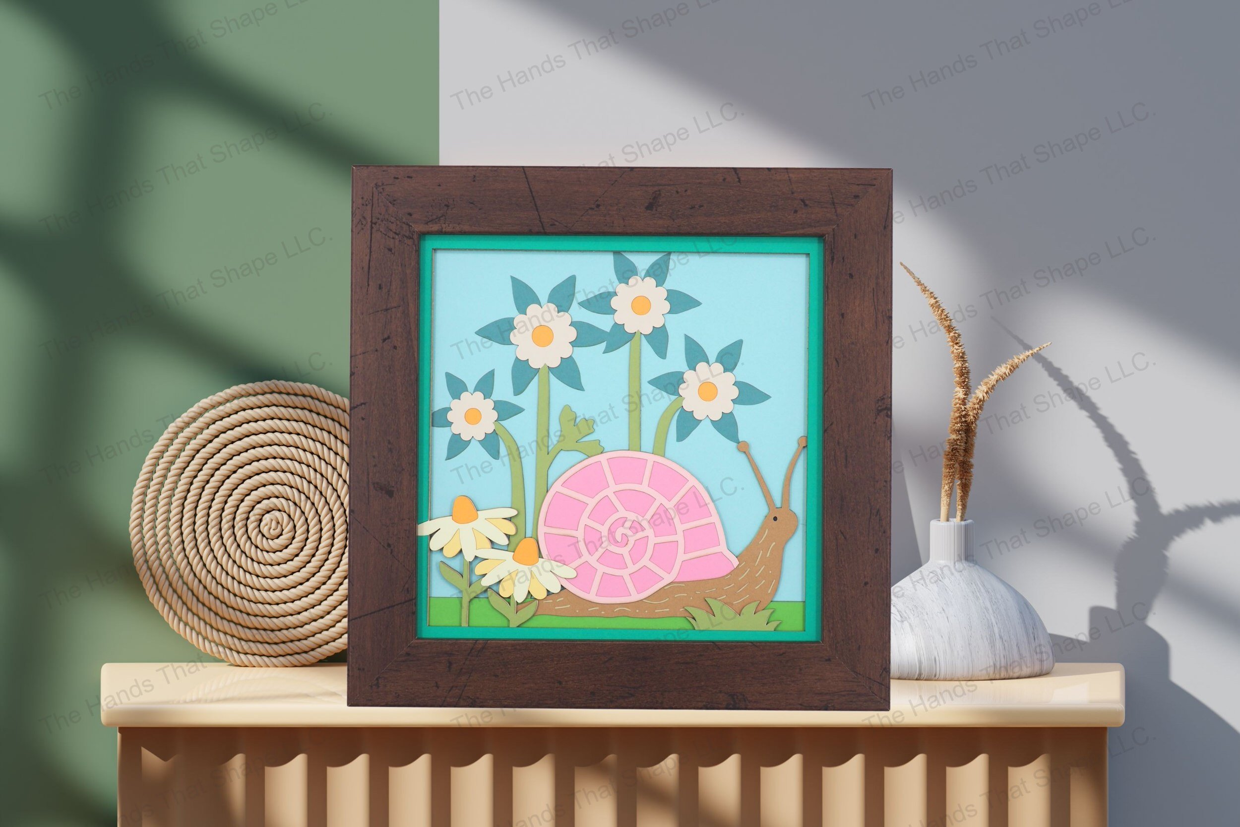 Admire this serene garden snail-themed artwork, elegantly displayed on a table, highlighting its vibrant layers and the peaceful essence of a lush garden.