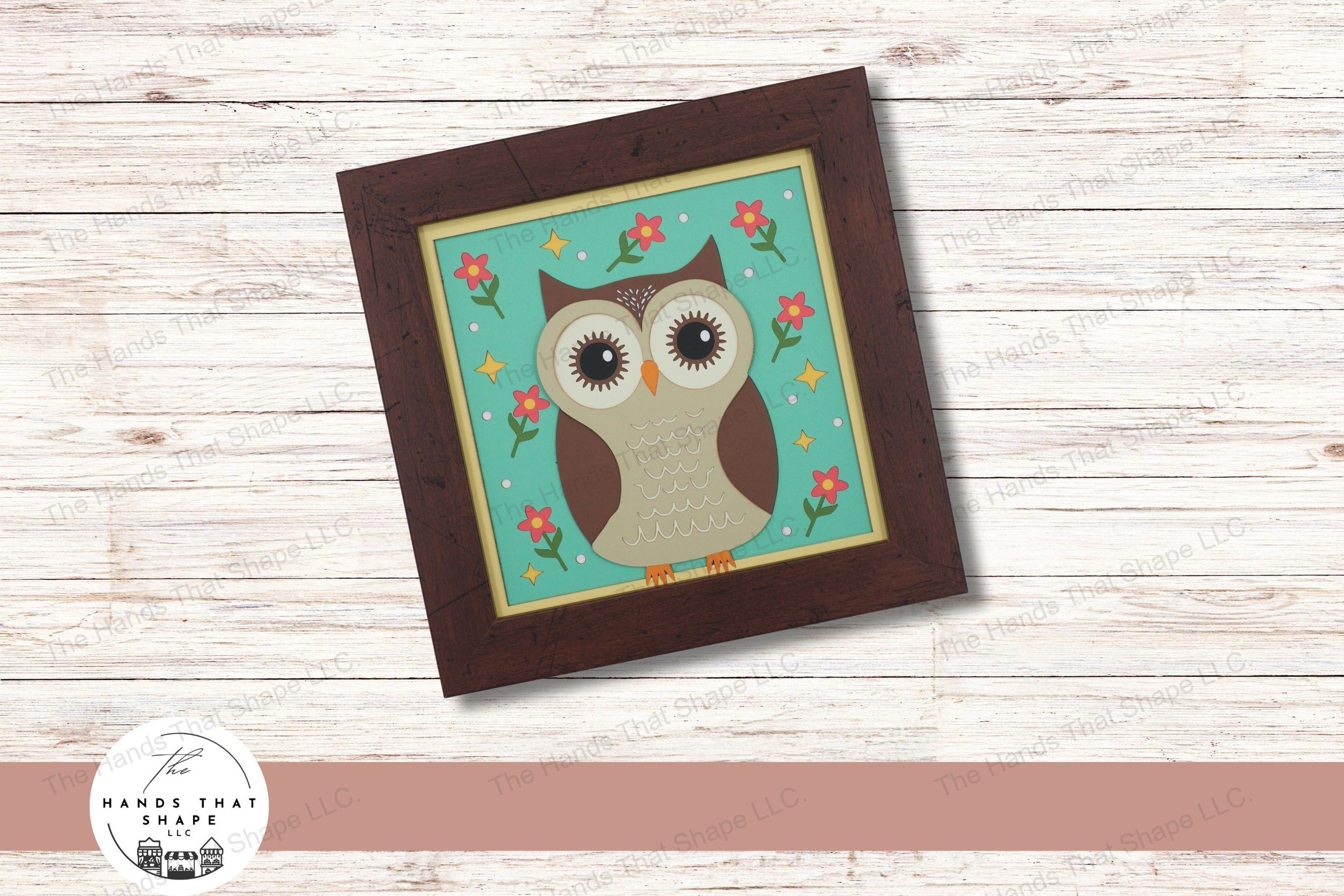 This layered cardstock art piece showcases a folksy owl, standing amidst a setting of flowers, dots, and stars, creating a charming and mystical woodland scene.