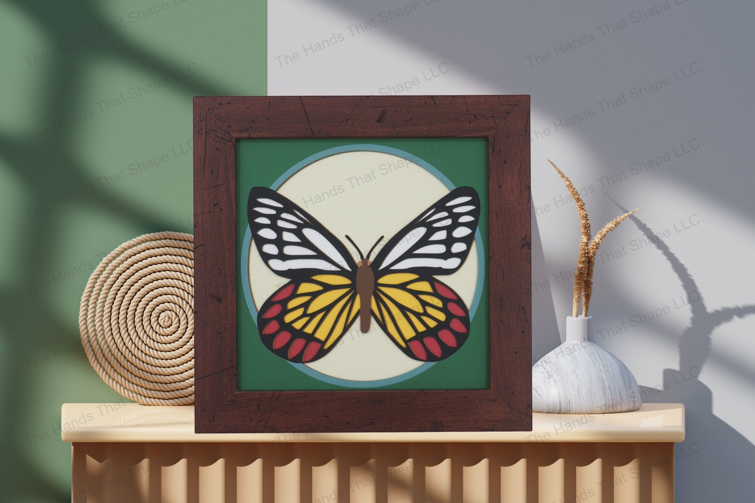 Admire this Delias Eucharis Butterfly-themed cardstock artwork, elegantly displayed on a table, highlighting its intricate layers and vivid color palette.